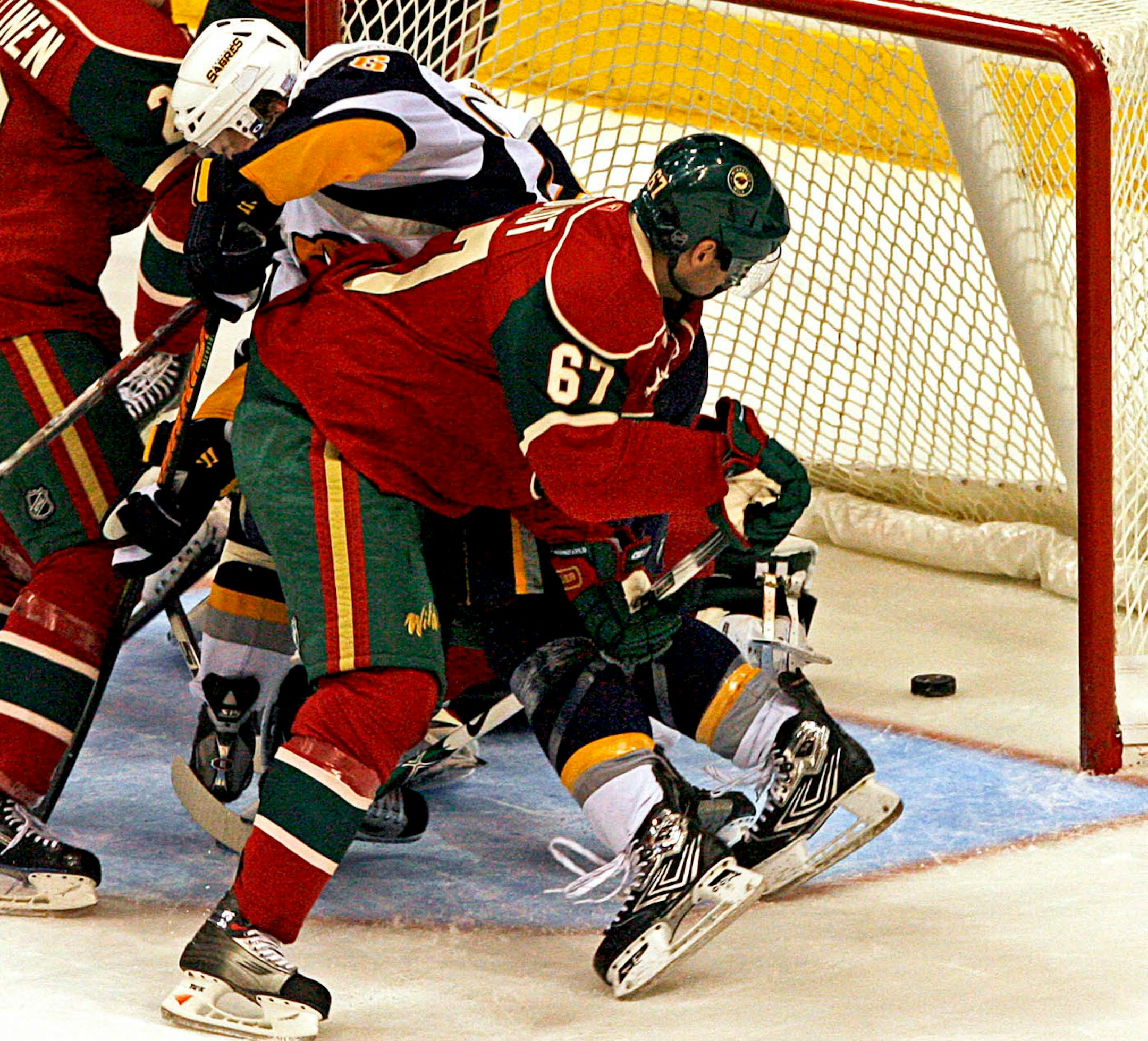 In the midst of a crowd of checked players in front of the Buffalo goal the puck slid in for the winning goal giving the Sabres 4-3 victory in overtime.