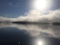 A June early morning fog burns from Lake Vermilion, by Tom Begich.