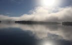 A June early morning fog burns from Lake Vermilion, by Tom Begich.