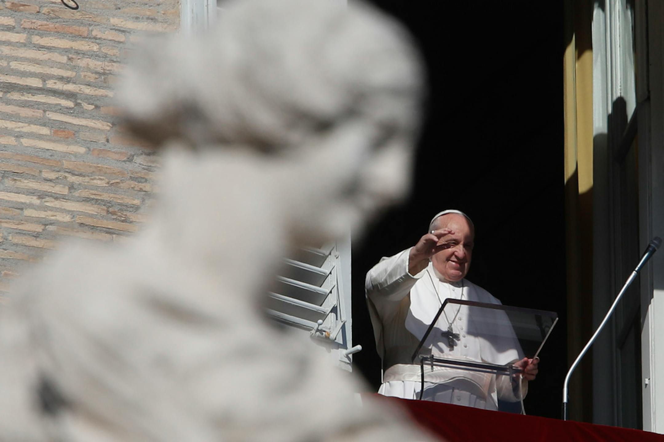 Pope Francis waves as he arrives for the Angelus noon prayer from the window of his studio overlooking St.Peter's Square, at the Vatican, Sunday, Nov. 8, 2020. (AP Photo/Alessandra Tarantino)