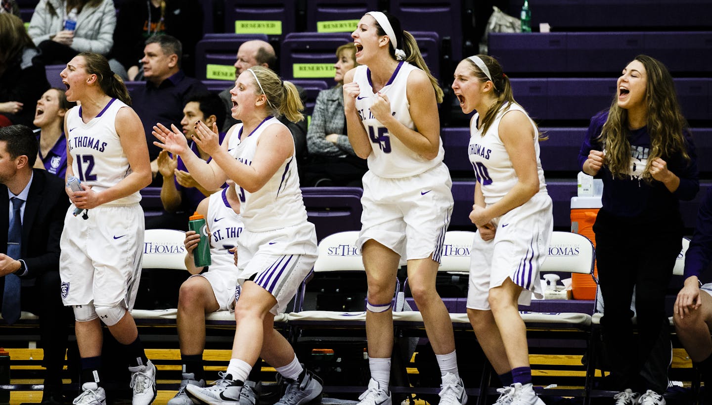 From left: Paige Gernes, Katie Stone, Kaitlin Langer and Lucia Renikoff cheer from the bench during a women's basketball game versus Gustavus Adolphus College January 6, 2016 in the Anderson Athletic and Recreation Complex's Schoenecker Arena. The Tommies beat the Gusties 67-45.