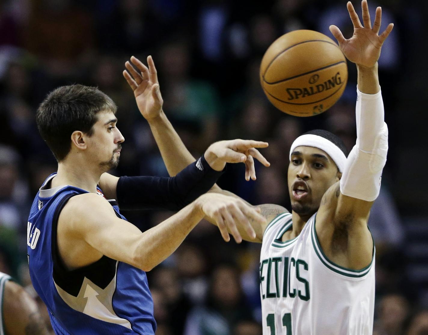 Timberwolves guard Alexey Shved passes the ball against Celtics guard Courtney Lee.