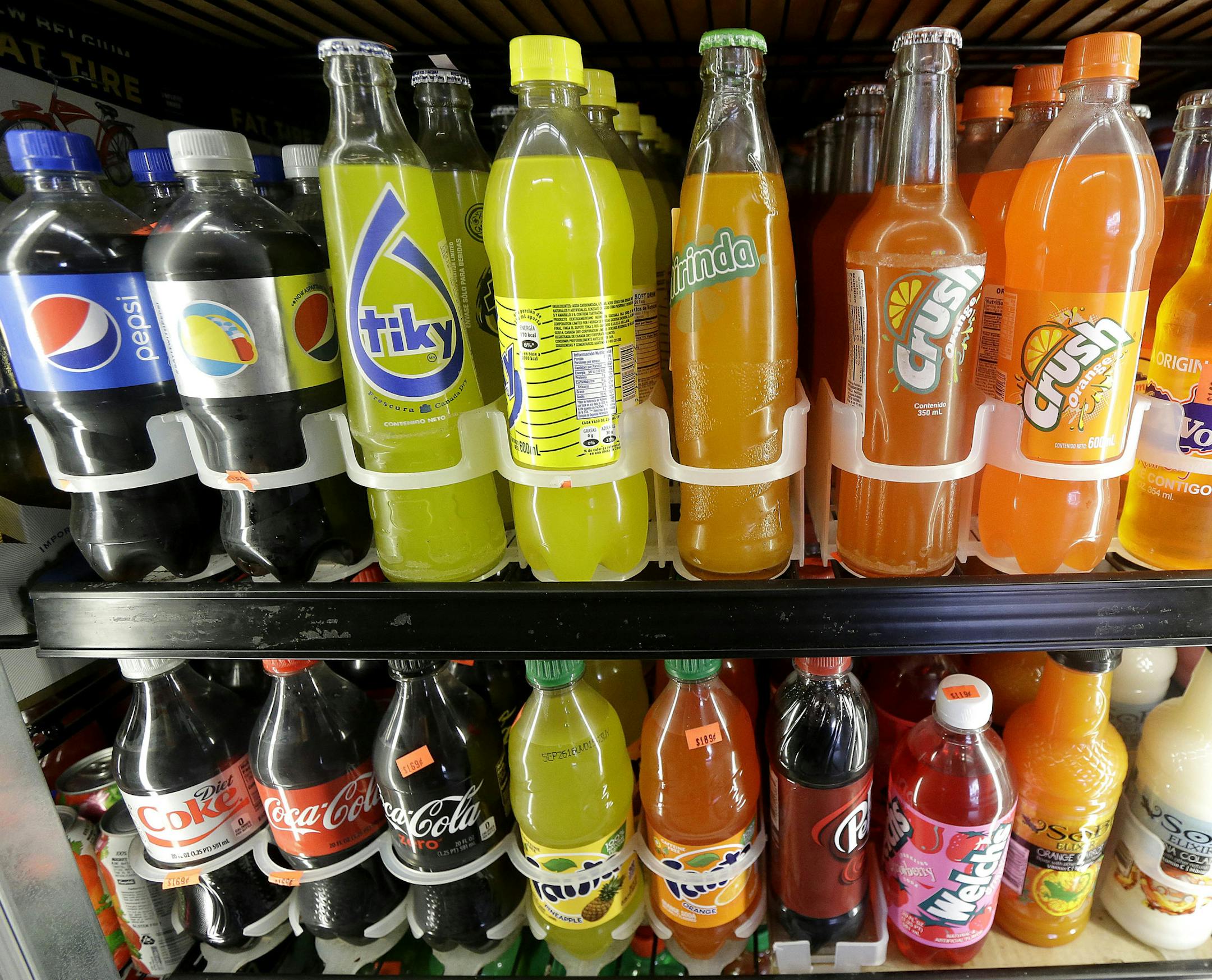 FILE - In this Wednesday, Sept. 21, 2016, file photo, soft drink and soda bottles are displayed in a refrigerator at El Ahorro market in San Francisco. After years of stamping out soda tax proposals with well-financed campaigns, Big Soda is suddenly finding itself up against bigger adversaries. In early November 2016, voters and lawmakers in five jurisdictions, including San Francisco and Chicagoís Cook County, approved special taxes on sugary drinks, with advocates chalking up the streak o