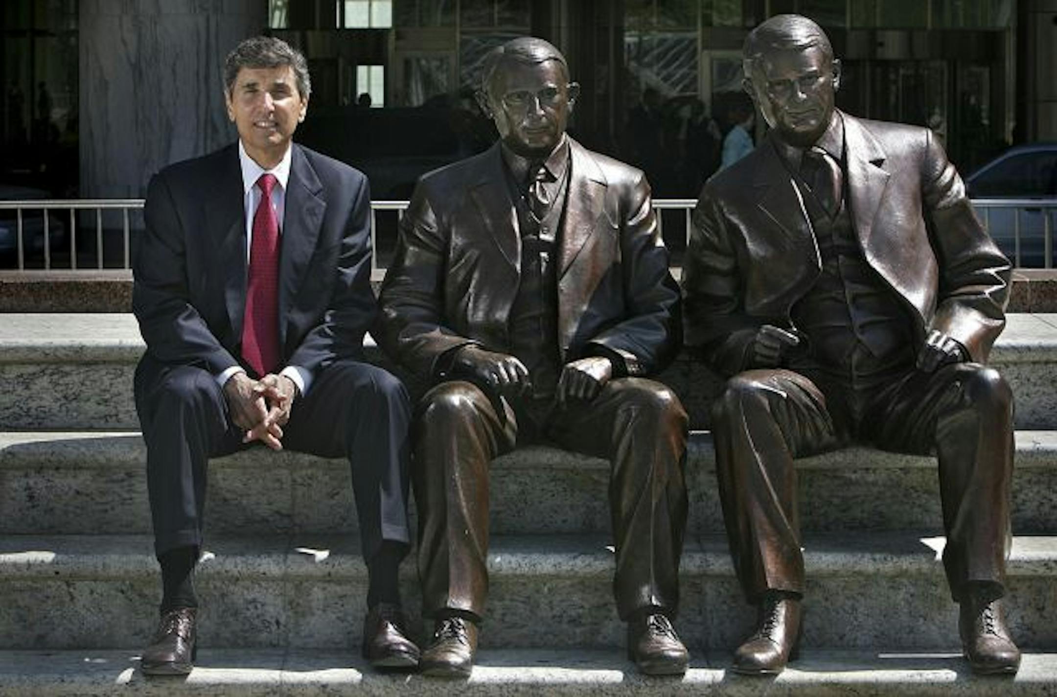 JIM GEHRZ � jgehrz@startribune.com Rochester/May 2007/11:30AM Dr. Denis Cortese is the CEO of the Mayo Clinic in Rochester. Seated next to Cortese are bronze sculptures of Dr. Charles H. Mayo (middle) and his brother, Dr. William J. Mayo. The sculptures, by U.S. artist Tuck Langland, are located outside the Gonda Building at the Clinic in the Feith Family Statuary Park.