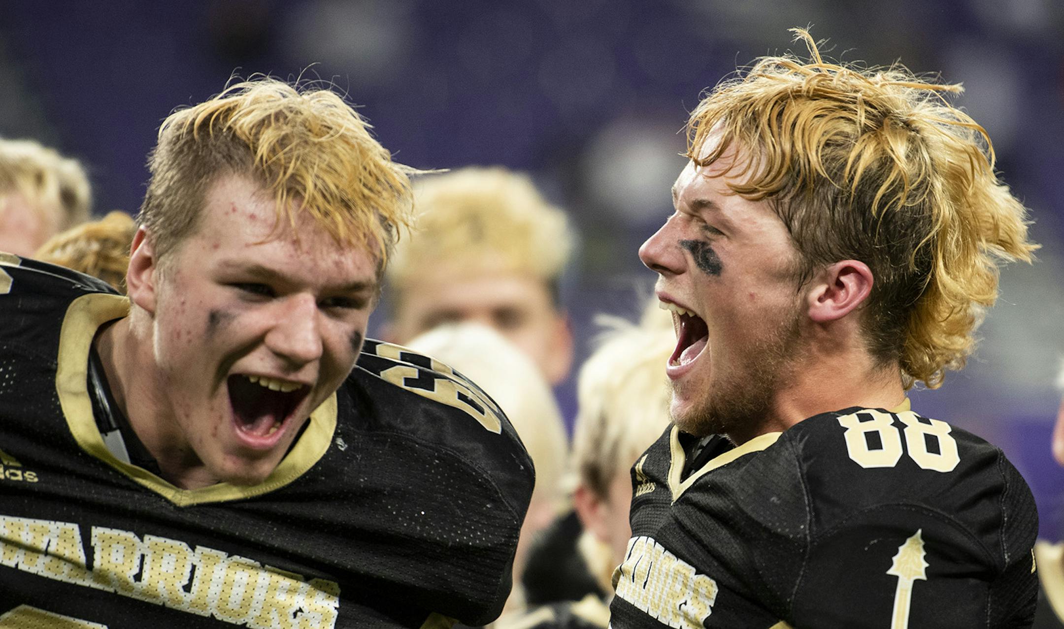 Caledonia Warriors wide receiver Cole Kronebusch, 88, and lineman Isaac Denstad, 62, celebrate the Warriors fifth straight Class AA championship during Prep Bowl XXXVIII at U.S. Bank Stadium on Friday, November 29, 2019. Caledonia beat the Polars 26-0 to complete an undefeated championship season.