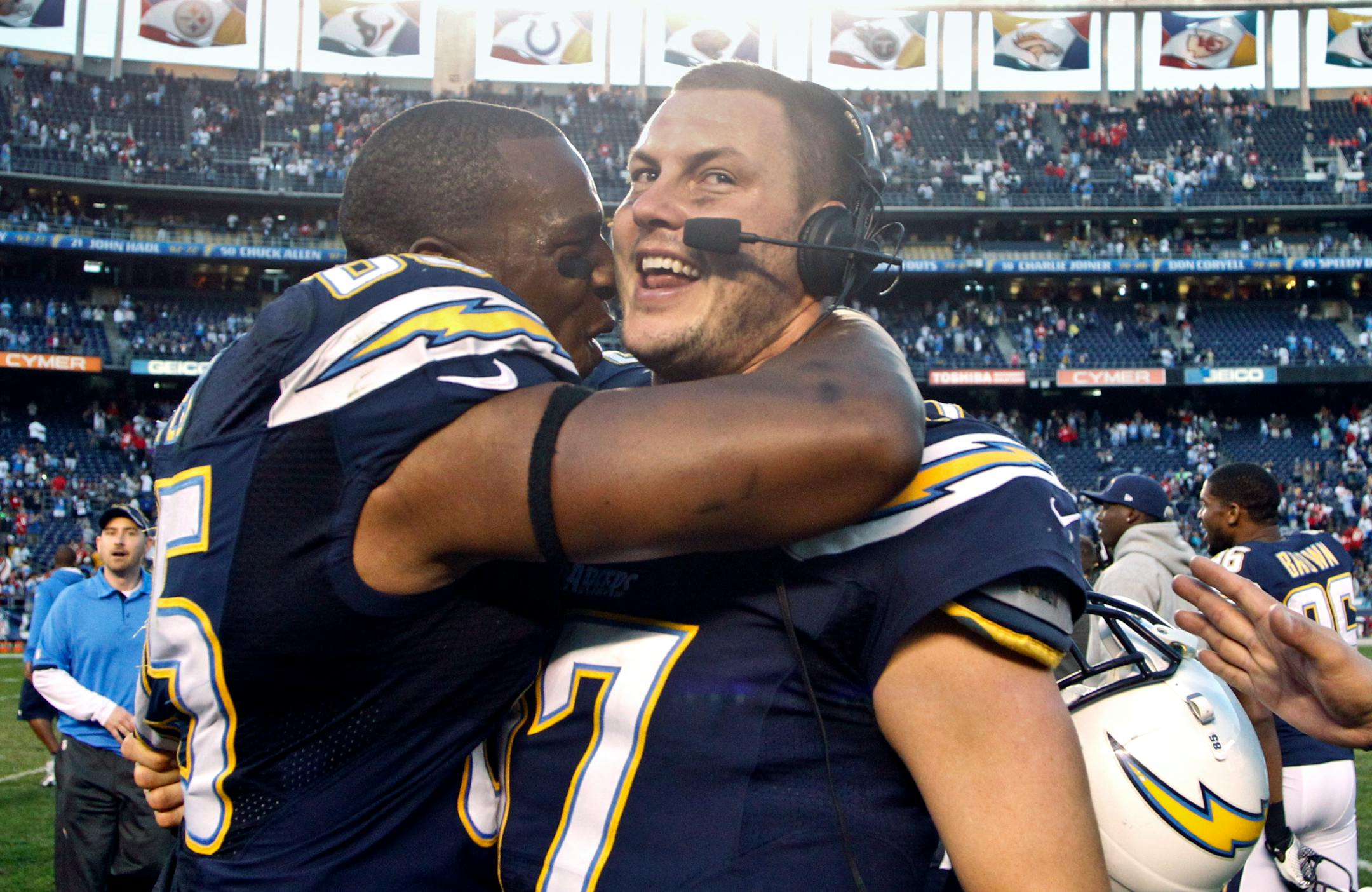 San Diego Chargers tight end Antonio Gates hugs quarterback Philip Rivers after the Chargers made the playoffs with a 27-24 overtime victory over the Kansas City Chiefs in an NFL football game, Sunday, Dec. 29, 2013, in San Diego. (AP Photo/Lenny Ignelzi )