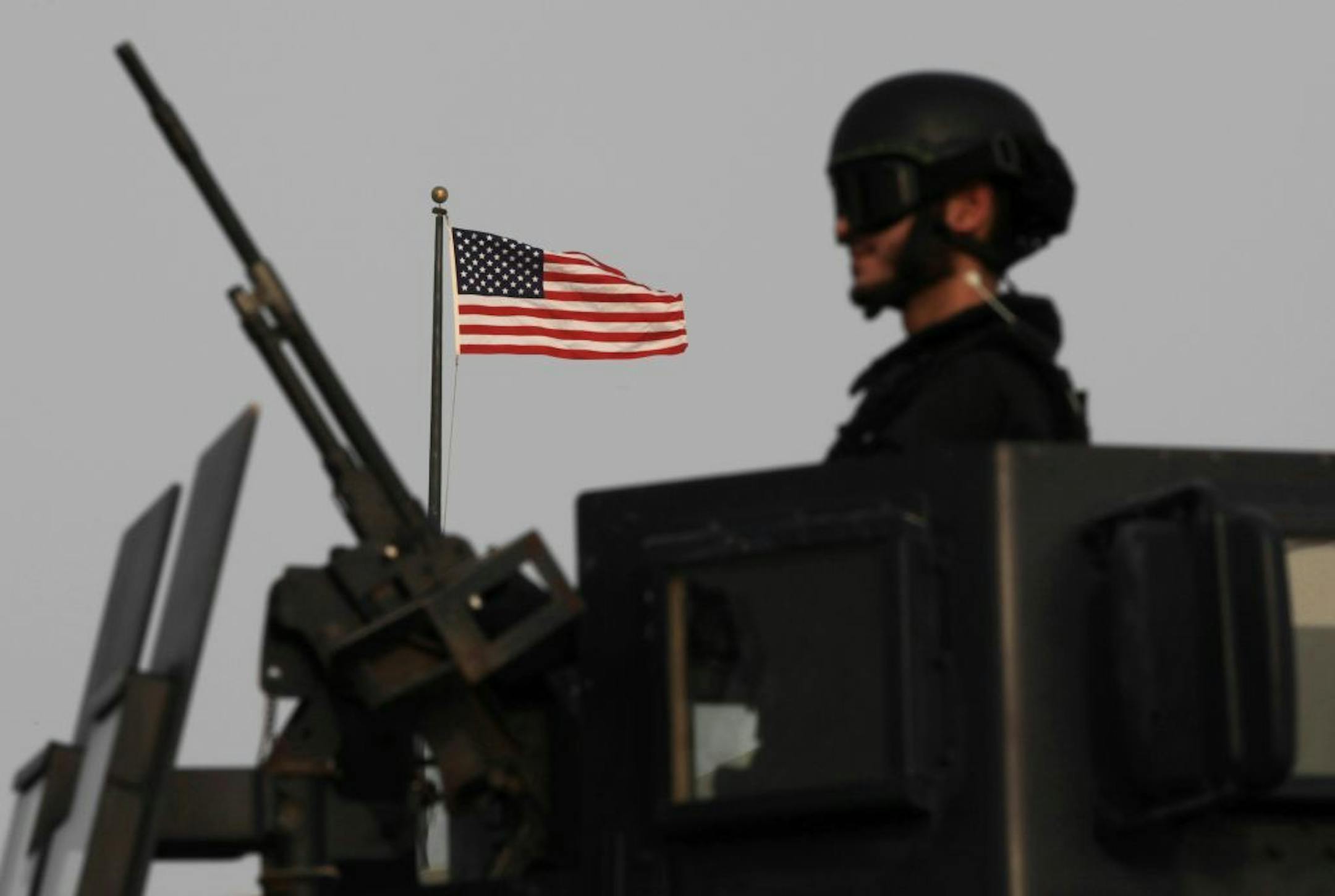 A Bahraini armored personnel vehicle reinforces U.S. Embassy security just outside a gate to the embassy building in Manama, Bahrain, on Sunday, Aug. 4, 2013.