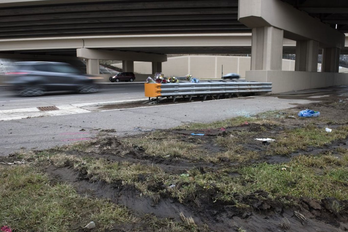 Flowers, tire tracks, and broken glass marked the scene of Thursday's fatal collision.