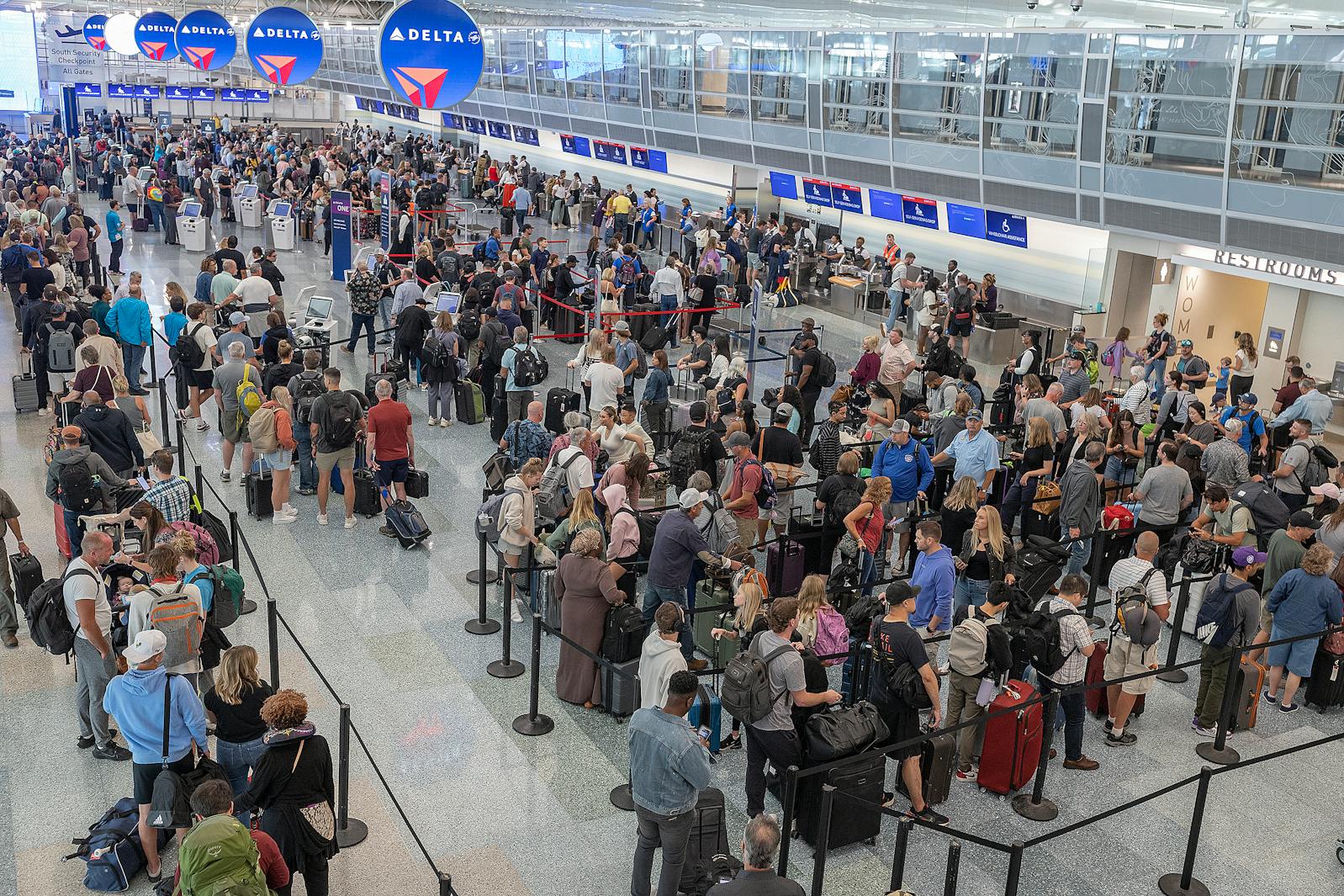 Passengers wait in line at Minneapolis-St. Paul International Airport in 2024. MSP is among the 40 airports nationally slated to see air traffic reductions because of the ongoing federal government shutdown.