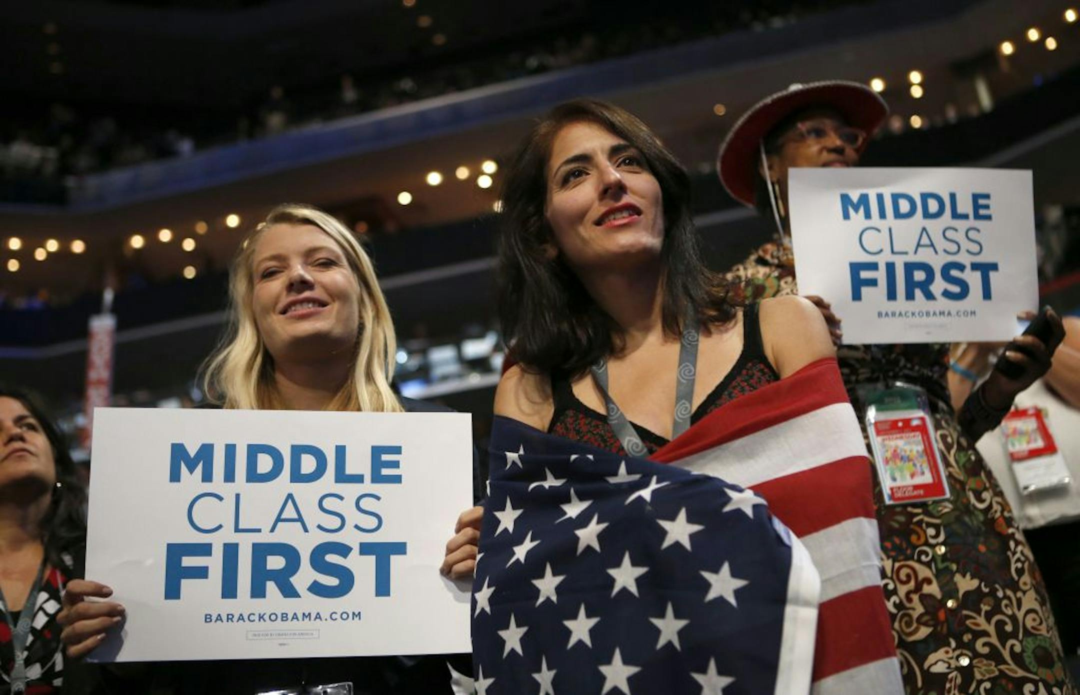 Delegates watch as Former President Bill Clinton addresses the Democratic National Convention in Charlotte, N.C., on Wednesday, Sept. 5, 2012.
