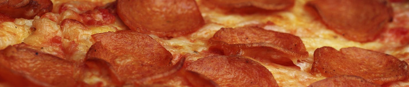 Closeup of pizza. Some frozen pizzas contain trans fat. iStock