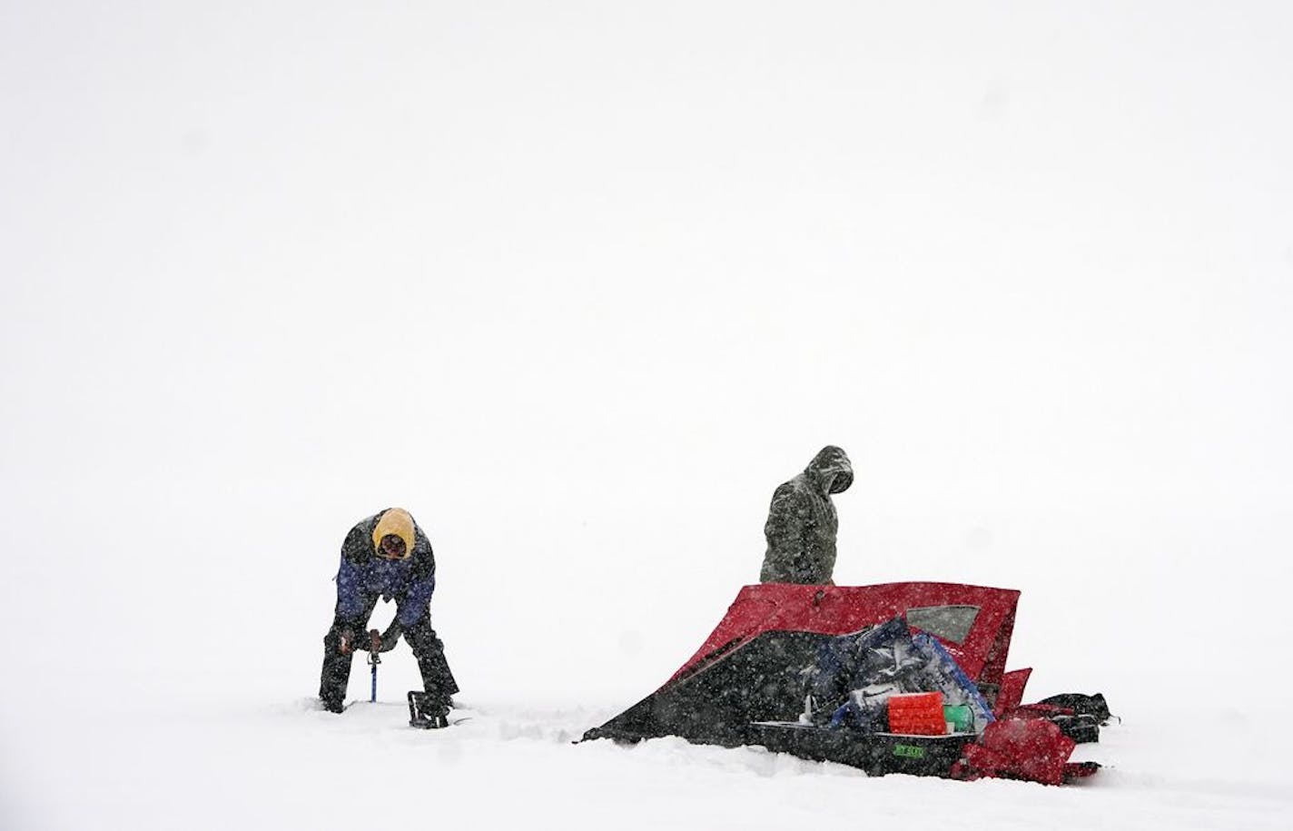 Daryl Larson, left, and Matt Berkowitz decided to use a snowy Sunday for ice fishing this morning on Bde Maka Ska, formerly Lake Calhoun, in Minneapolis on Sunday, Feb. 9, 2020. They were going for some perch and walleye.