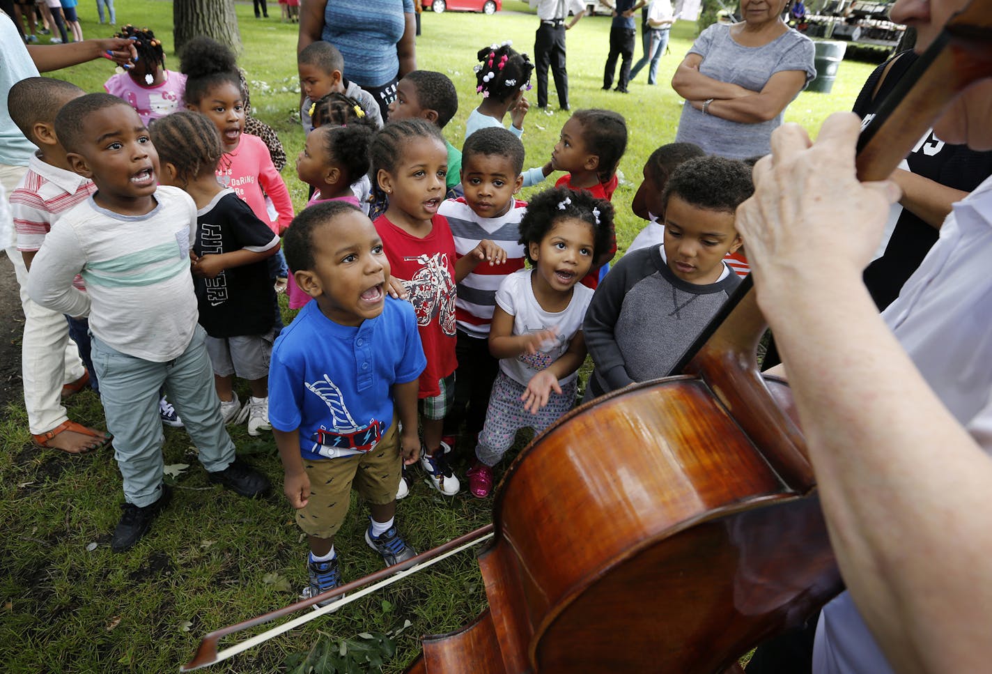 Children from Agape Early Learning Child Development Center sing "Old MacDonald Had a Farm" accompanied by cellist Faith Farr of Minnesota Sinfonia at Webber Park in north Minneapolis. ] (Leila Navidi/Star Tribune) leila.navidi@startribune.com BACKGROUND INFORMATION: The Hopewell Music Children's Festival at Webber Park in north Minneapolis on Wednesday, June 15, 2016. The day began with instrument demonstrations for children with musicians from Minnesota Sinfonia, a professional nonprofit orche