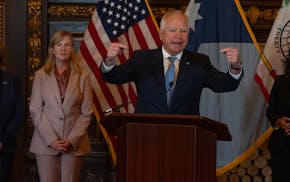 DFL Senator Erin Murphy left, DFL Representative Melissa Hortman, listens as Gov. Tim Walz speaks, Rep. Speaker of the House Lisa Demuth, at right loo