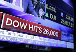 FILE - In this Tuesday, Jan. 16, 2018, file photo, a television screen on the floor of the New York Stock Exchange headlines the Dow Jones industrial 