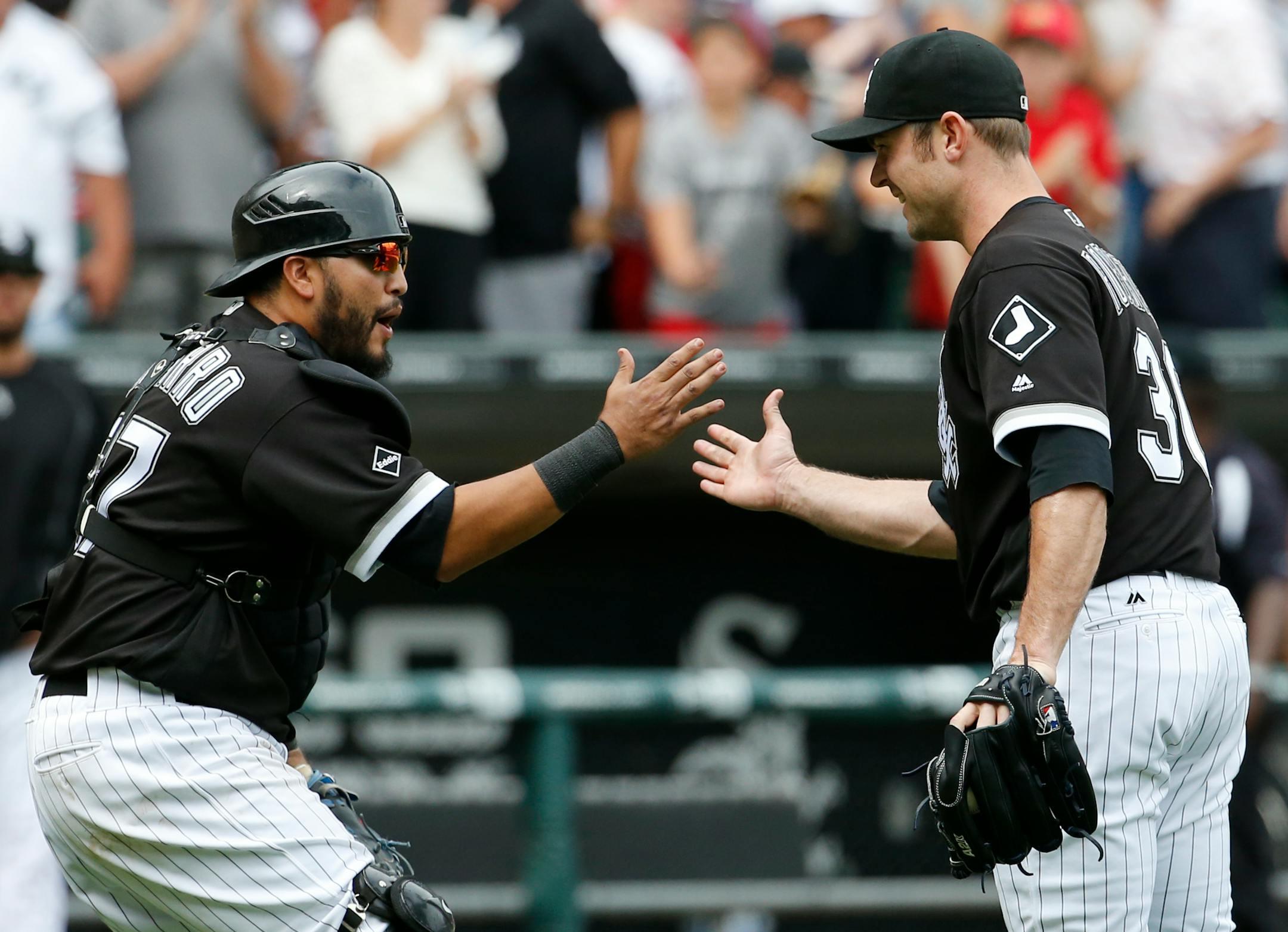 Chicago White Sox closer David Robertson, right, celebrates with catcher Dioner Navarro after they defeated the Minnesota Twins 6-5 in a baseball game in Chicago, Thursday, June 30, 2016. (AP Photo/Nam Y. Huh)