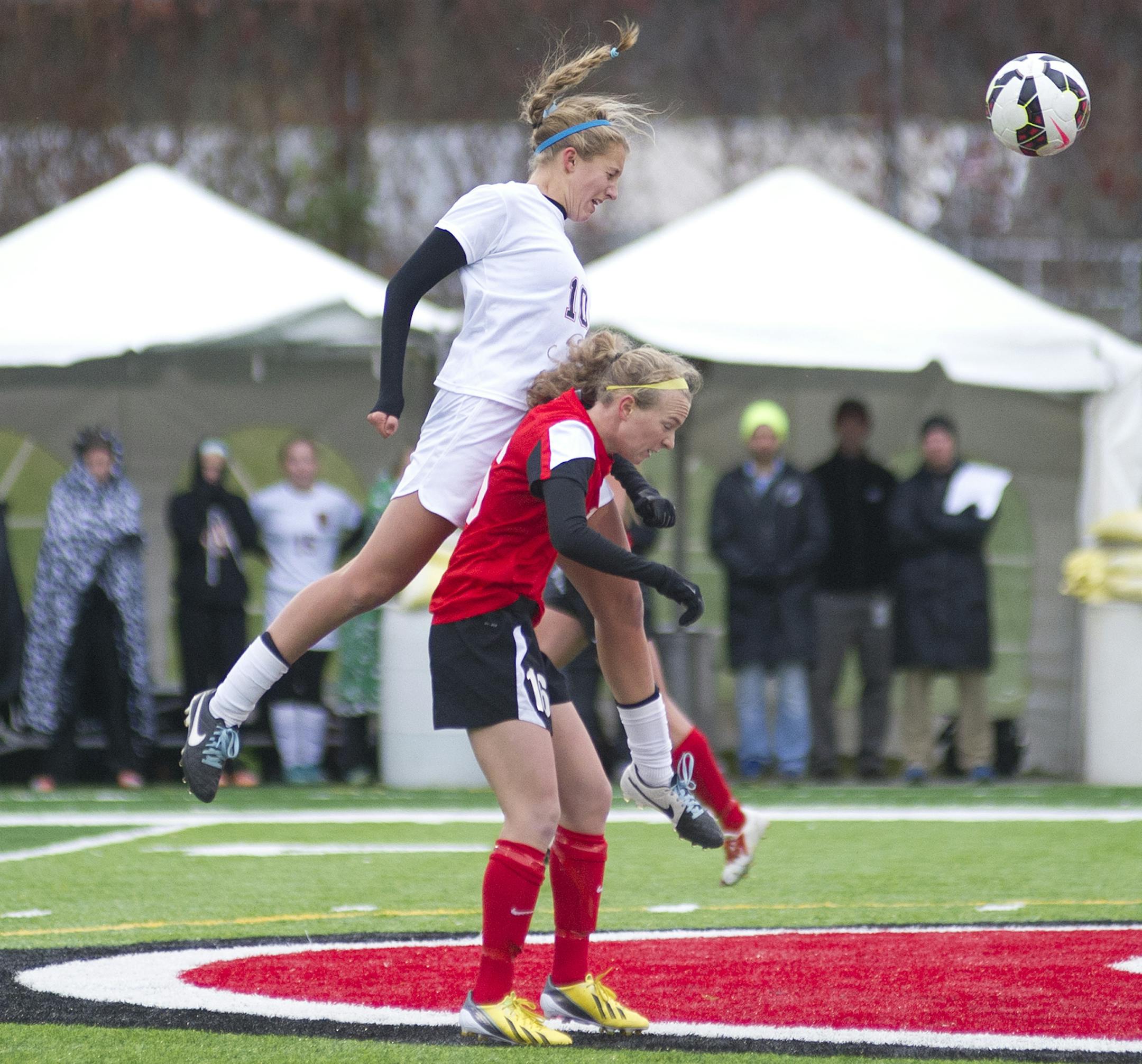 Lakeville North's Temi Carda leaps over the back of Eden Prarie's April Bockin to make a header during the second half of the Class 2A girls' soccer state semifinal Tuesday, October 28th, 2014 at Husky Stadium in St. Cloud, MN. ] (Matthew Hintz, 102814, St. Cloud)