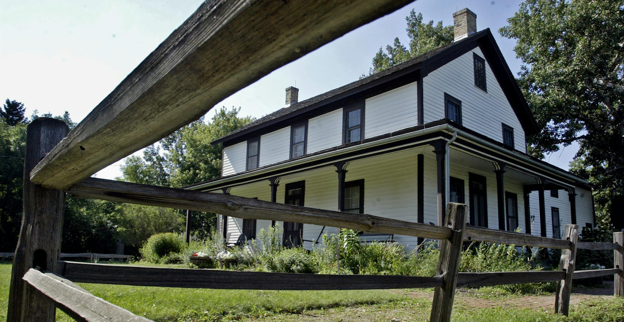 Marlin Levison - Strib 07/31/05 - Assign#97790 - There are a number of historically interesting homes tucked away in various Twin Cities neighborhoods that were originally quaint farm homes, lake cottages, etc. that are now open for inspection by the public on a summer weekend outing.
IN THIS PHOTO: The Gibbs family farm is an example of farm architecture of the 1800's. It is open for tours led by folks dressed in period costume.