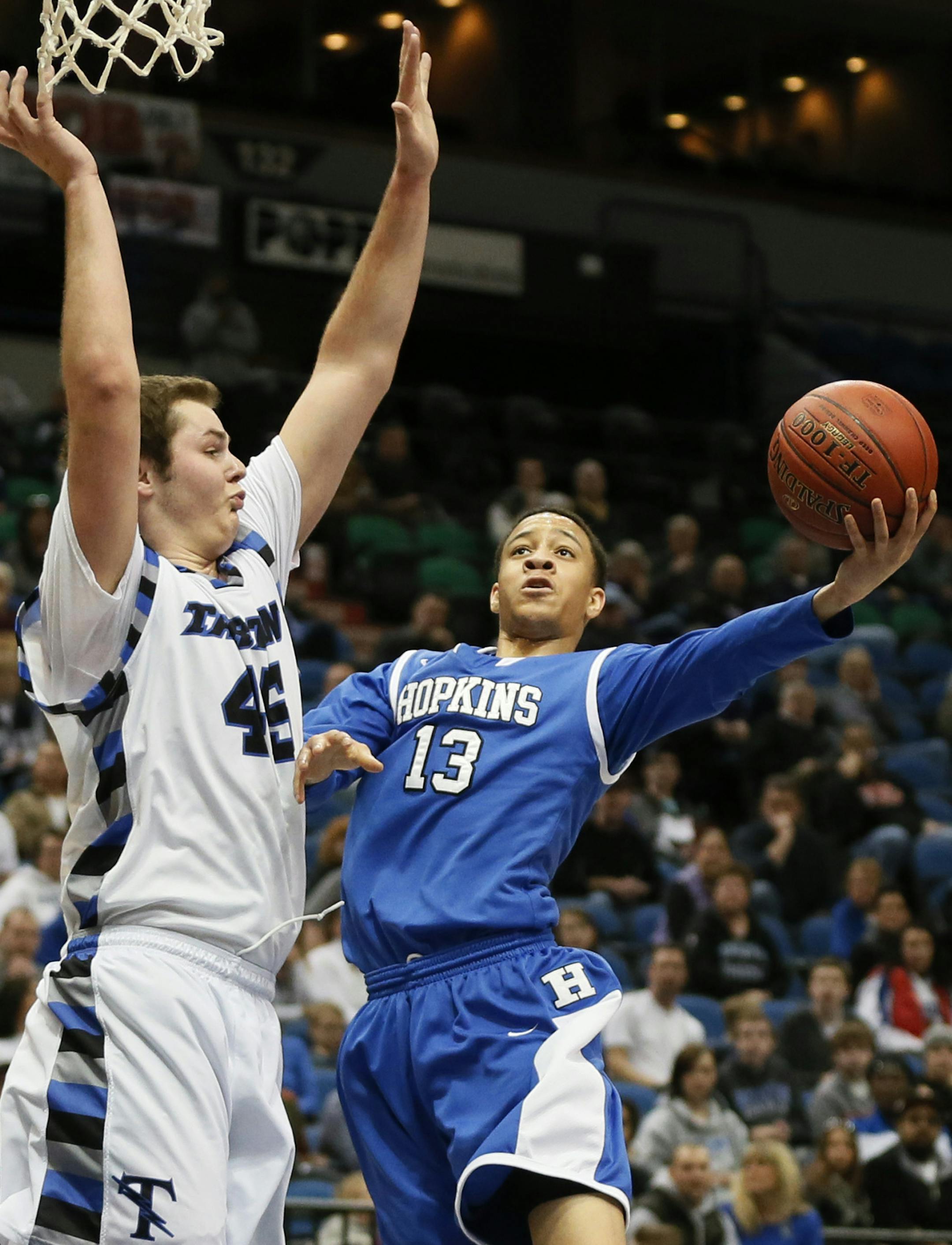 Hopkins Amir Coffey shoots a hook shot over Brody Jackson of Tartan during class 4-A quarter final action between Tartan and Hopkins high school's basketball at Target Center March 12, 2014 in Minneapolis, MN.] JERRY HOLT jerry.holt@startribune.com Jerry Holt