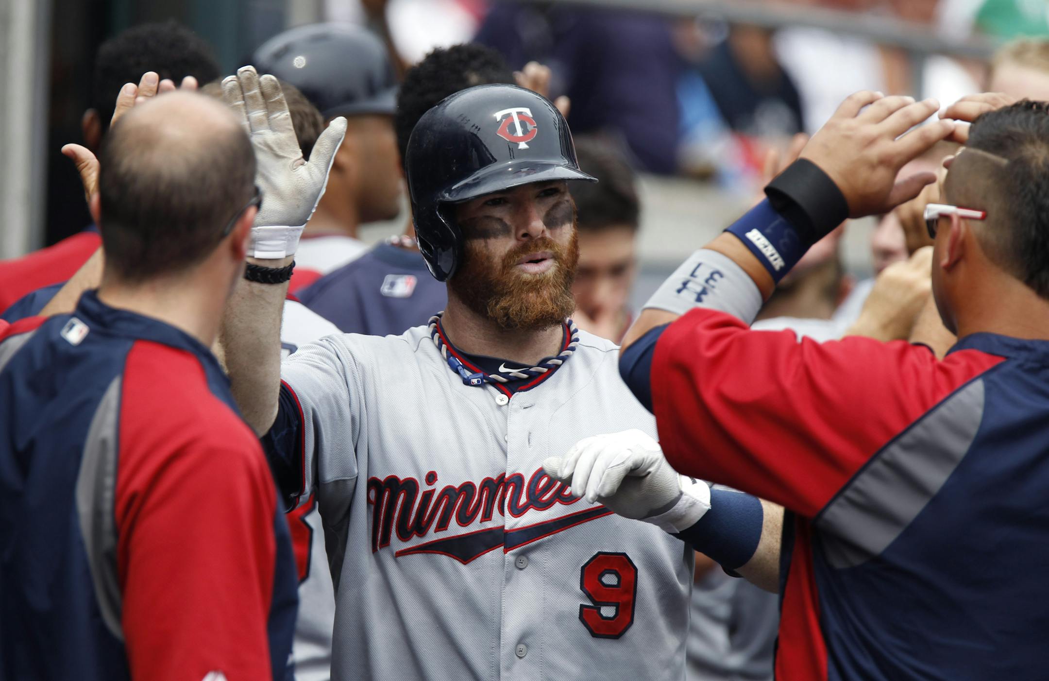 Minnesota Twins' Ryan Doumit is congratulated in the dugout after hitting three-run home run against the Detroit Tigers in the fifth inning of a baseball game Thursday, Aug. 22, 2013 in Detroit. (AP Photo/Duane Burleson