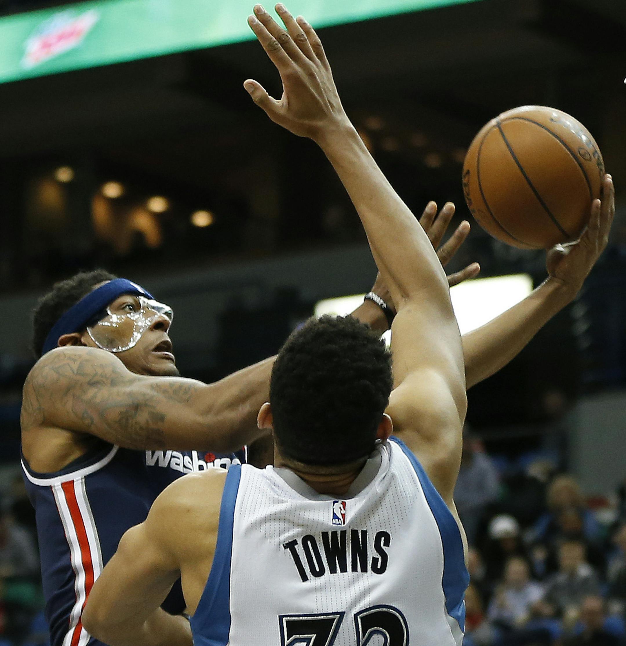 Washington Wizards guard Bradley Beal (3) goes up to the basket against Minnesota Timberwolves forward Karl-Anthony Towns (32) in the second half of an NBA basketball game Wednesday, March 2, 2016 in Minneapolis. The Wizards won 104-98. (AP Photo/Stacy Bengs)