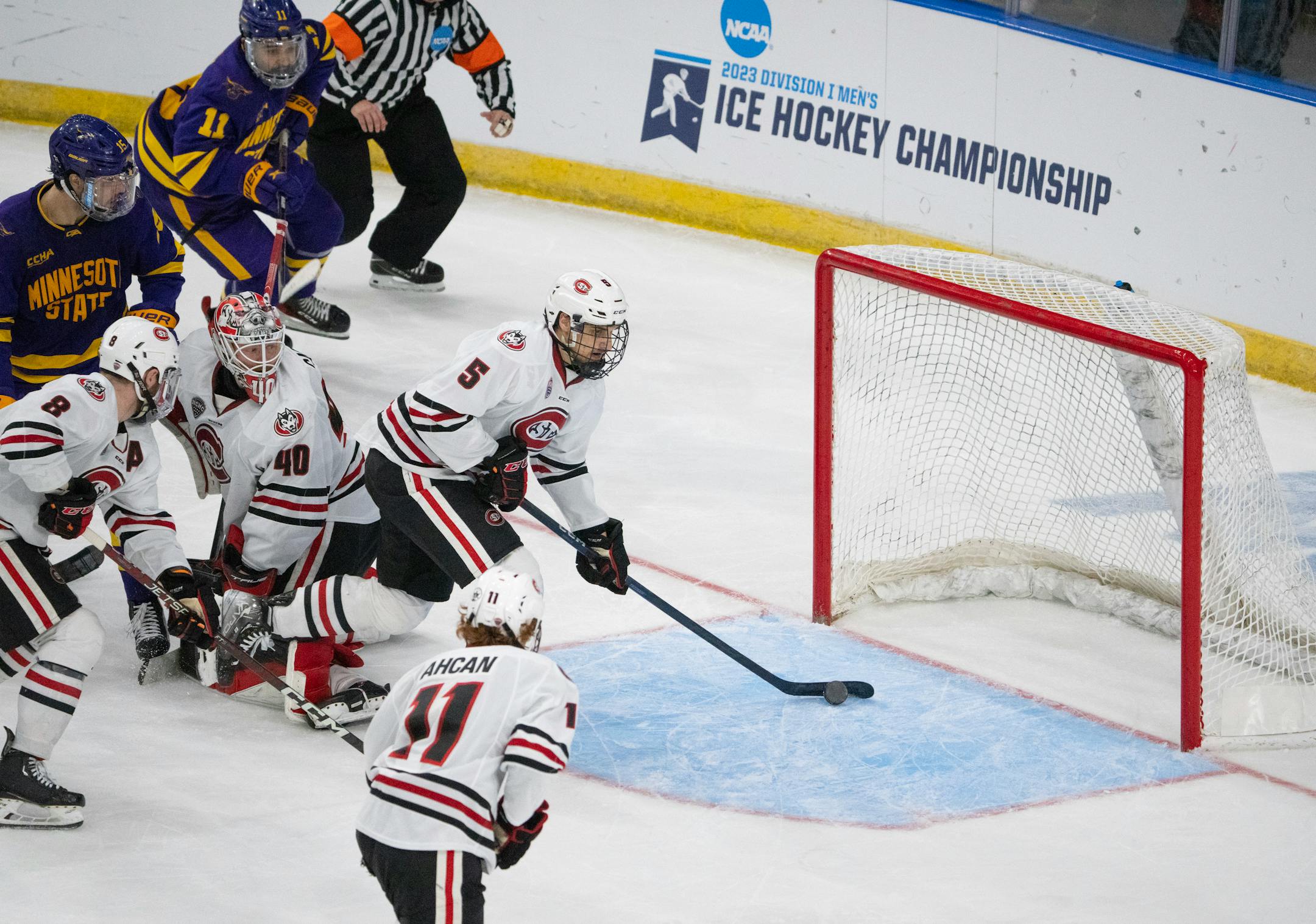 St. Cloud State Huskies defenseman Ondrej Trejbal (5) backed up Huskies goaltender Jaxon Castor (40) and cleared a puck rolling towards the goal in the third period.