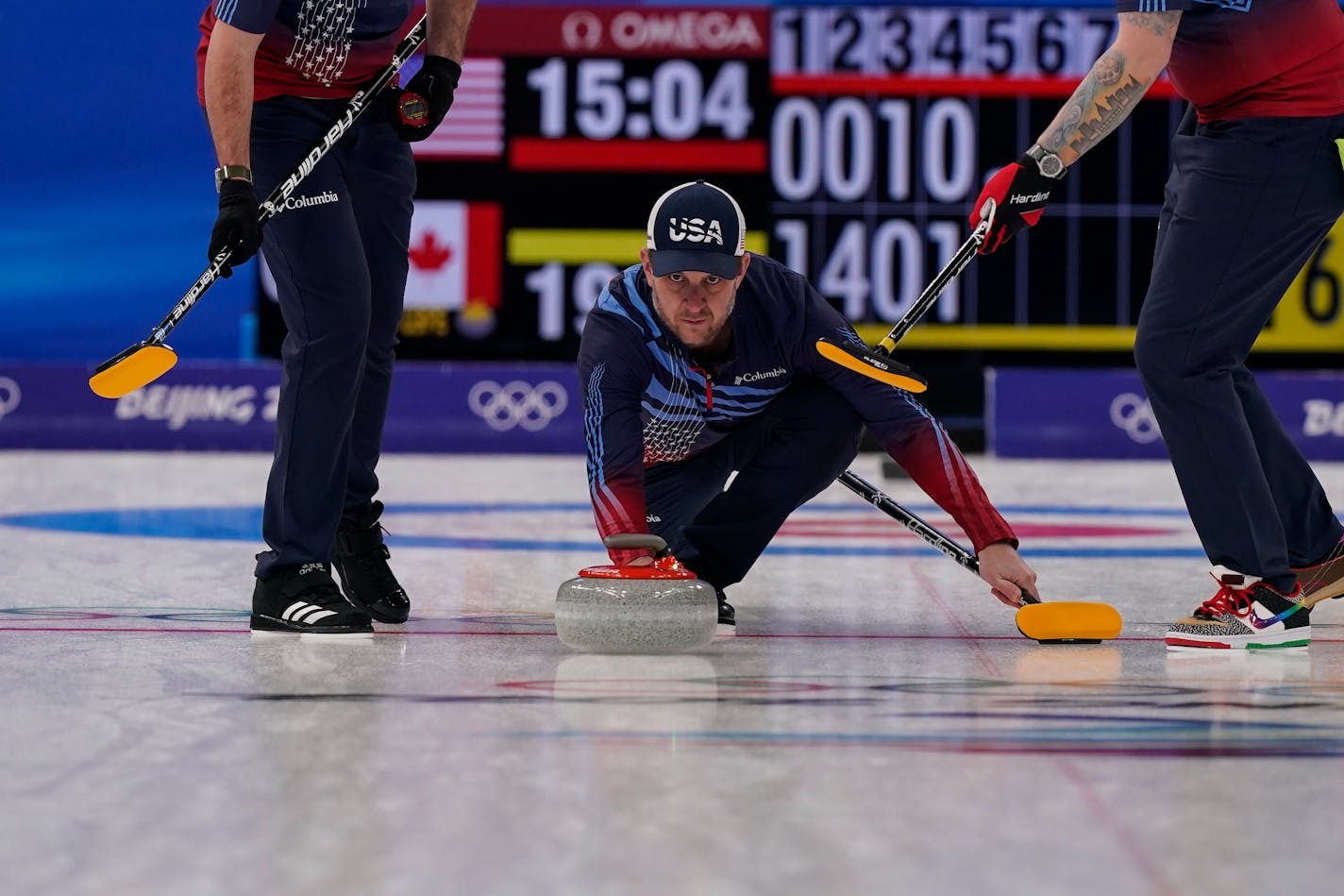 United States' John Shuster throws a rock during a men's curling match against Canada at the Beijing Winter Olympics on Sunday