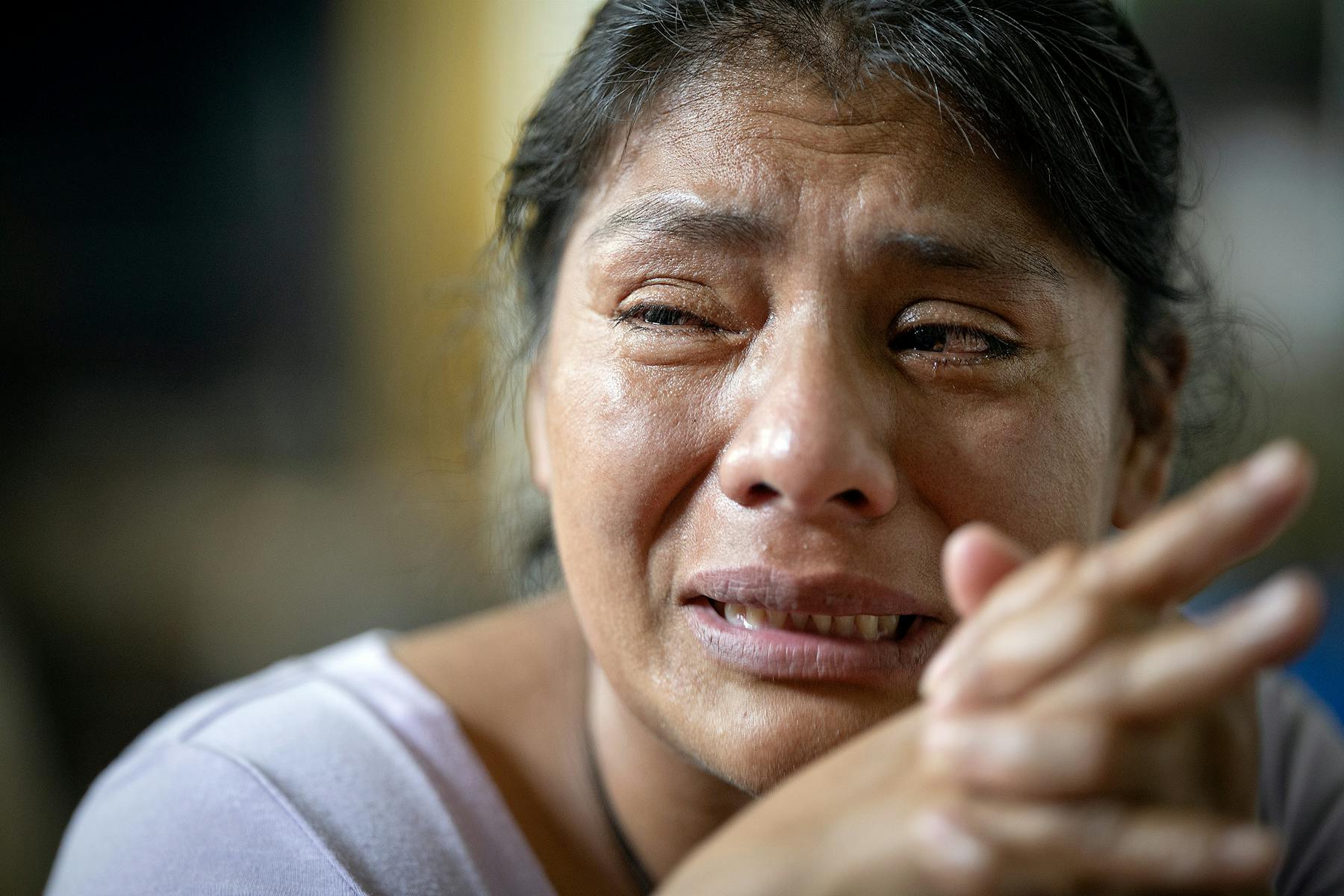 Patricia weeps as she shares about the journey she made leaving her children and coming to Minnesota.