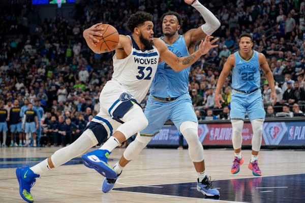 Minnesota Timberwolves center Karl-Anthony Towns (32) drives past Memphis Grizzlies forward Xavier Tillman during the second half in Game 4 of an NBA 