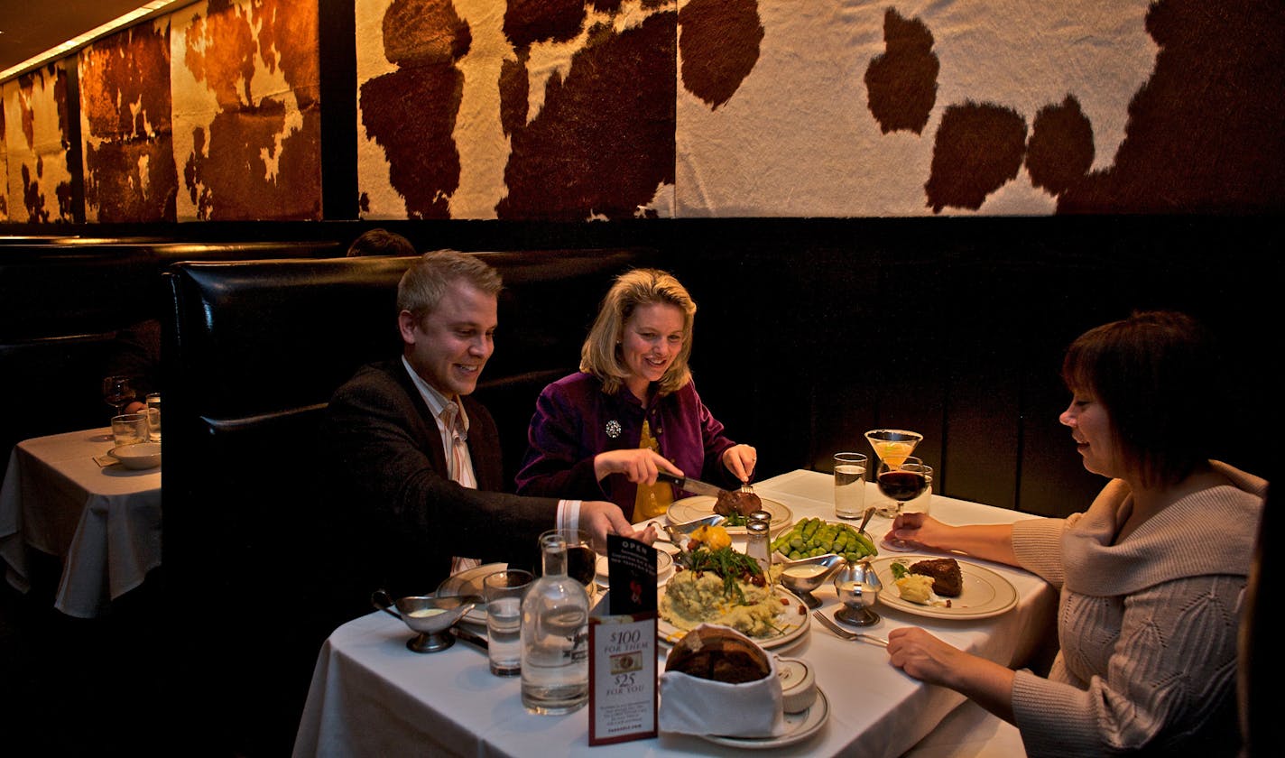 From left, Tony Lane, Carrie Faust and Laurie Blum enjoy a meal at Manny's Steakhouse. In August, the 20-year-old restaurant moved into new, high-profile digs in the landmark Foshay Tower.