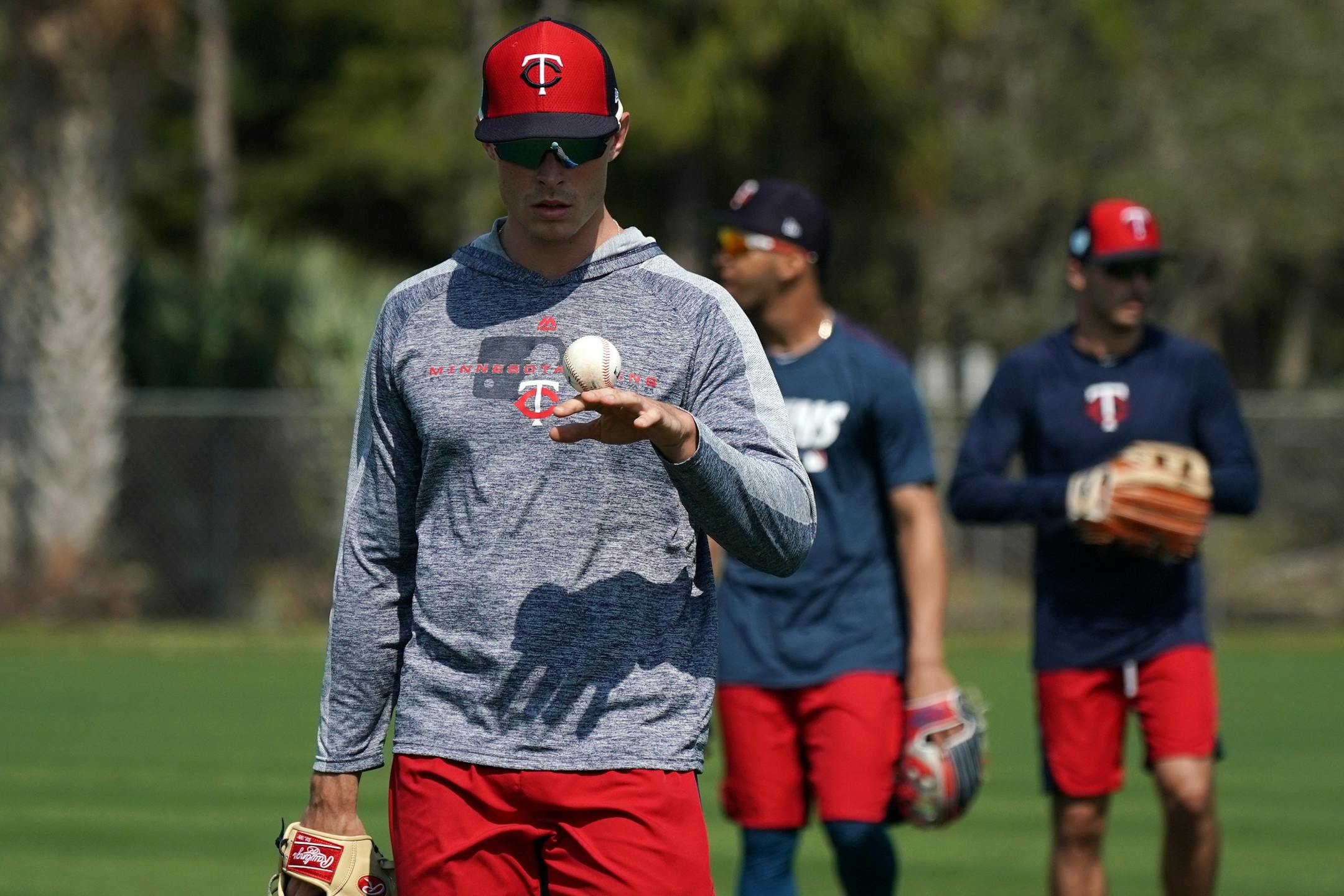 Minnesota Twins right fielder Max Kepler (26) balanced a baseball on the back of his hand as he walked off the field after informal drills with the few field players present at Spring Training Saturday.