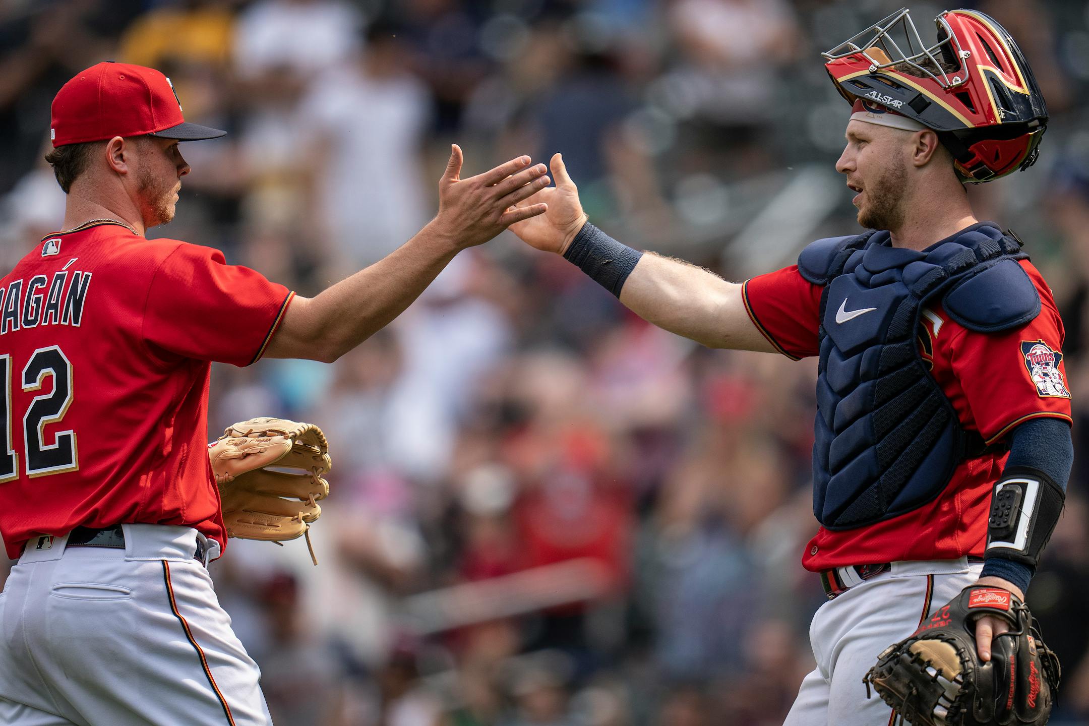 Minnesota Twins catcher Ryan Jeffers (27) congratulated relief pitcher Emilio Pagan (12) on the last out of the game.