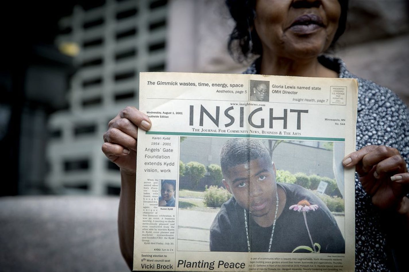 Jeanette Blevins held up a 2001 article displaying the photo of her nephew Thurman Blevins, featuring him planting a peace garden, during a press conference in front of Minneapolis City Hall, Monday, July 9, 2018 in Minneapolis, MN.