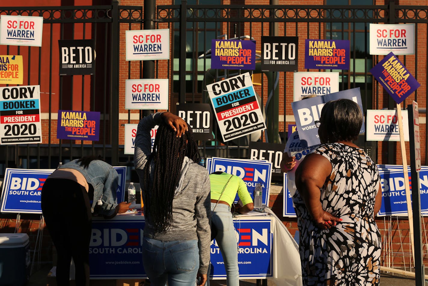 Campaign signs of Democratic presidential hopefuls cover a fence outside the site of a fish fry held annually by Rep. Jim Clyburn during the South Carolina Democrats' state convention, in Columbia, S.C., June 21, 2019.