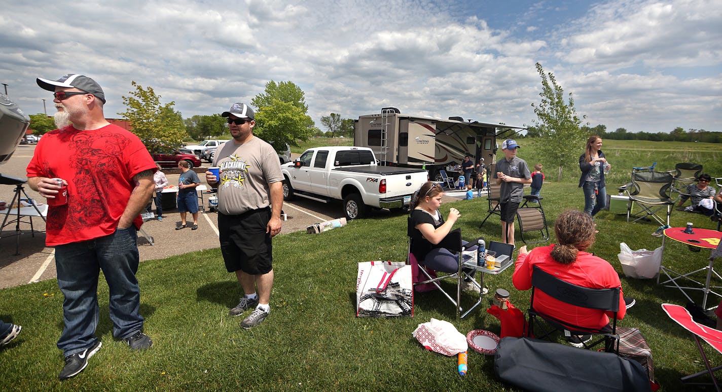 Parents of players for the Easton Synergy AAA hockey team mingled between games in a parking lot at the Schwan Super Rink in Blaine.