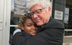 Mark Andrew embraces Deea Elliott after he advocated that her assault conviction be expunged from her record, five years after she participated in a M