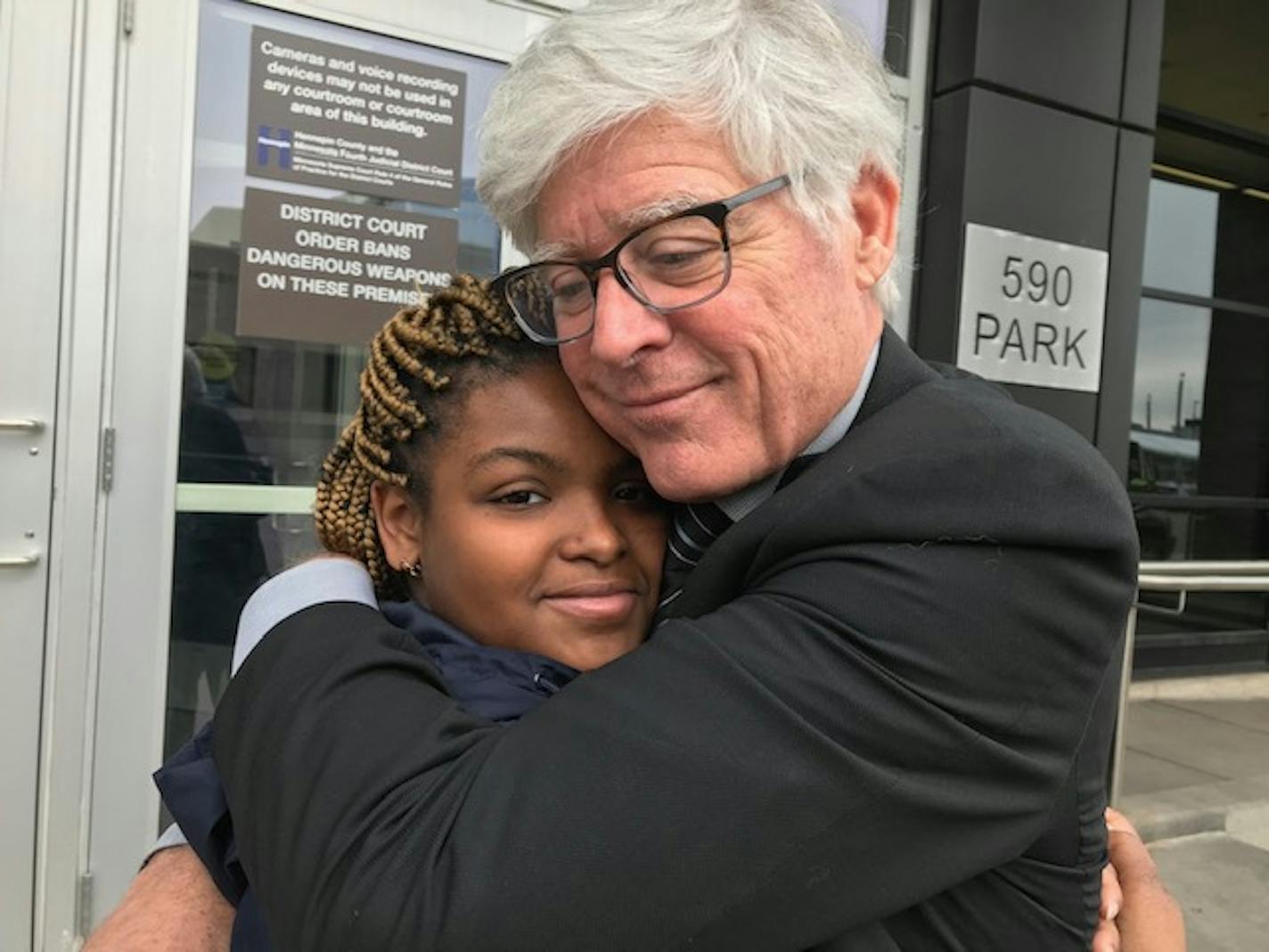 Mark Andrew embraces Deea Elliott after he advocated that her assault conviction be expunged from her record, five years after she participated in a Mall of America attack that left him seriously injured. PHOTO BY RANDY FURST