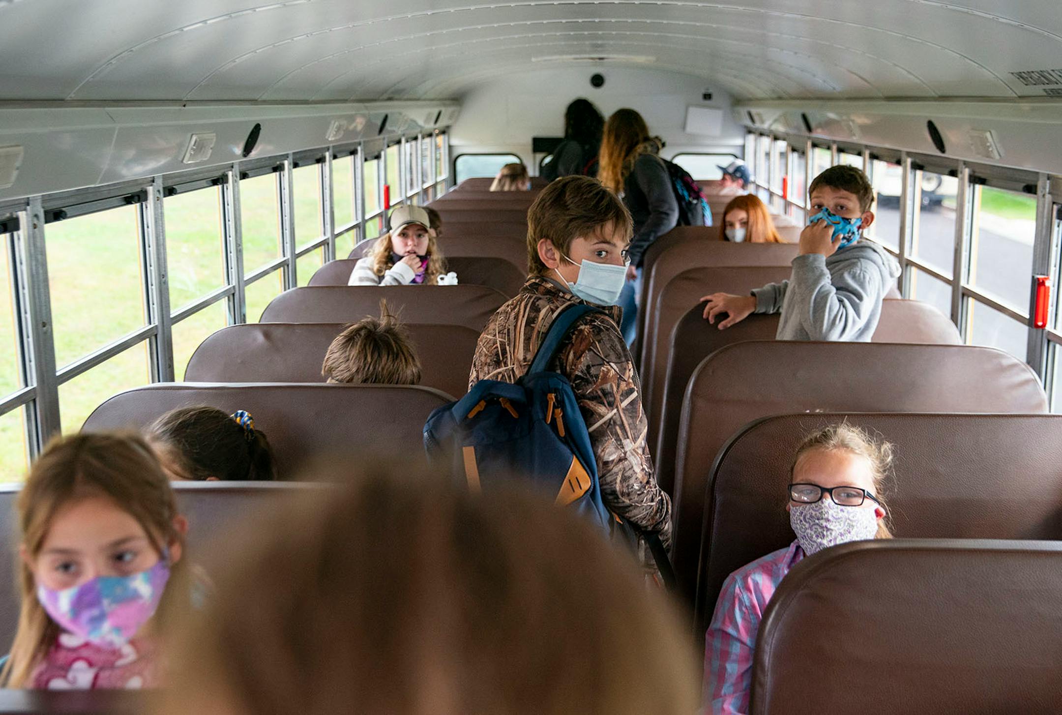 Students loaded onto a school bus outside Carlton High School at the end of the first day of class on Tuesday.