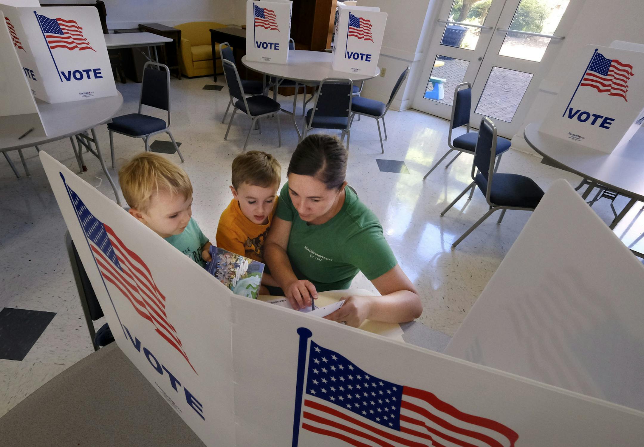 Tosha Tillman, right, brought her sons, Bodhi Dove, 3, left, and Huxley Dove, 6, with her Tuesday, June 12, 2018 as she voted in the House and Senate primary election in Winchester, Va. (Scott Mason /The Winchester Star via AP)