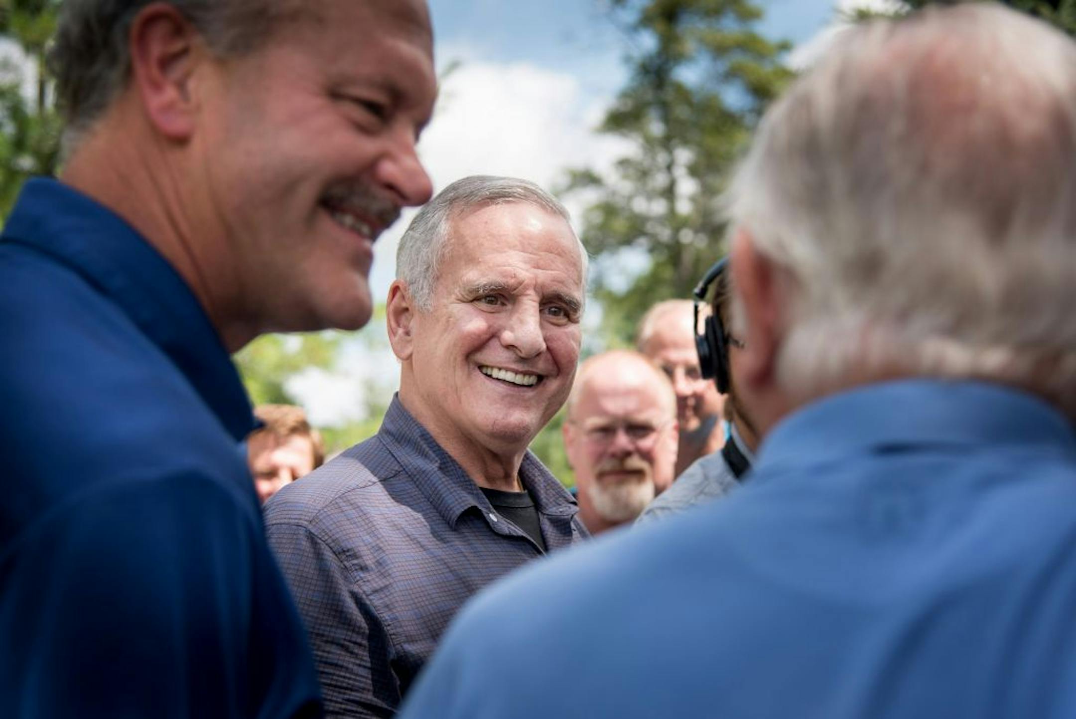 Gov. Mark Dayton, center, meets with Minnesota Power CEO Al Hodnik, left and Dutch Cragun, owner of Cragun's Resort, when he came to Nisswa, Minn. to survey the damage from recent storms on Friday, July 17, 2015. (Glen Stubbe/Star Tribune via AP) ST. PAUL PIONEER PRESS OUT; MAGS OUT; TWIN CITIES LOCAL TELEVISION OUT; MANDATORY CREDIT