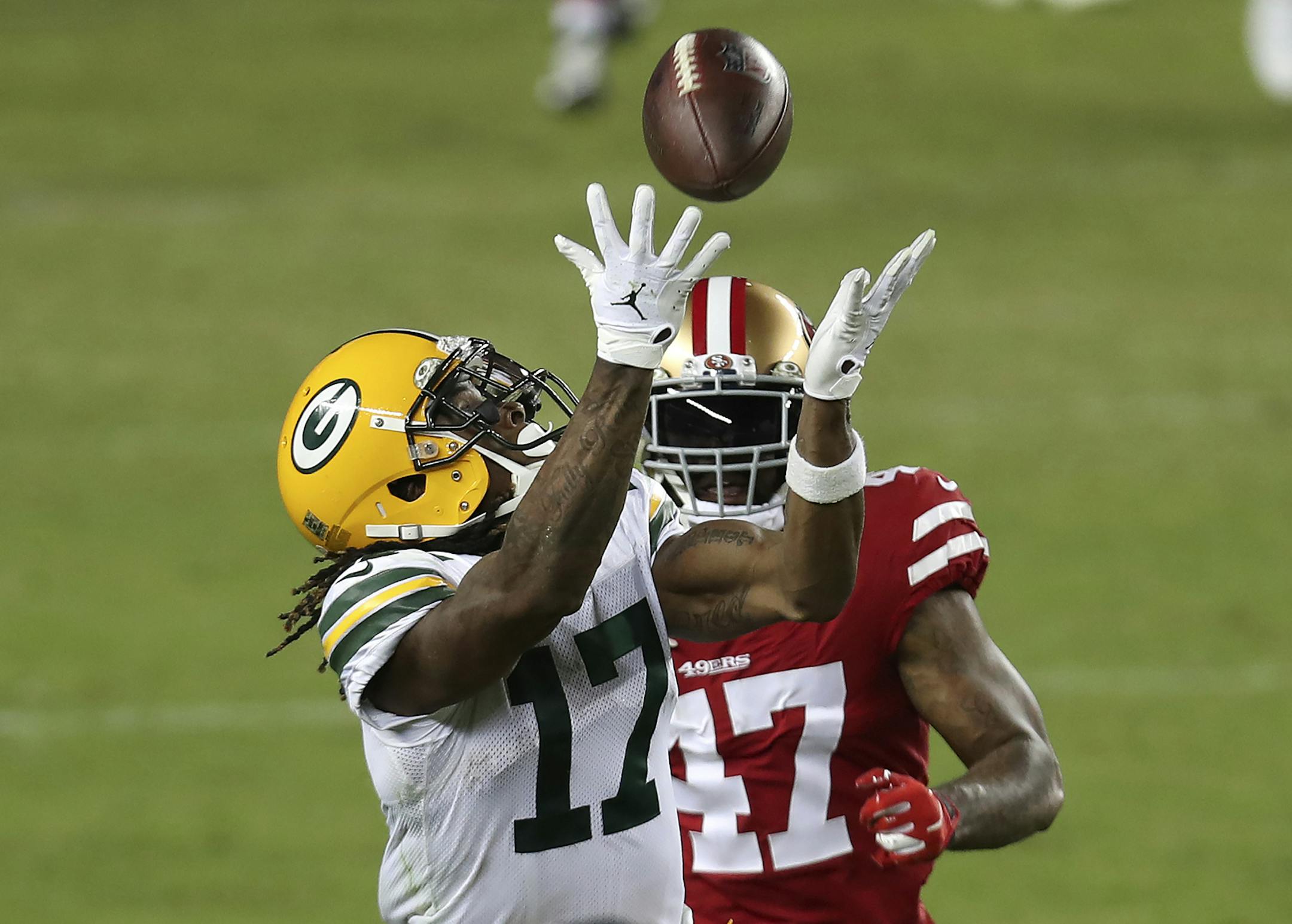Green Bay Packers wide receiver Davante Adams (17) catches a pass in front of San Francisco 49ers cornerback Jamar Taylor (47) during the second half of an NFL football game in Santa Clara, Calif., Thursday, Nov. 5, 2020. (AP Photo/Jed Jacobsohn)