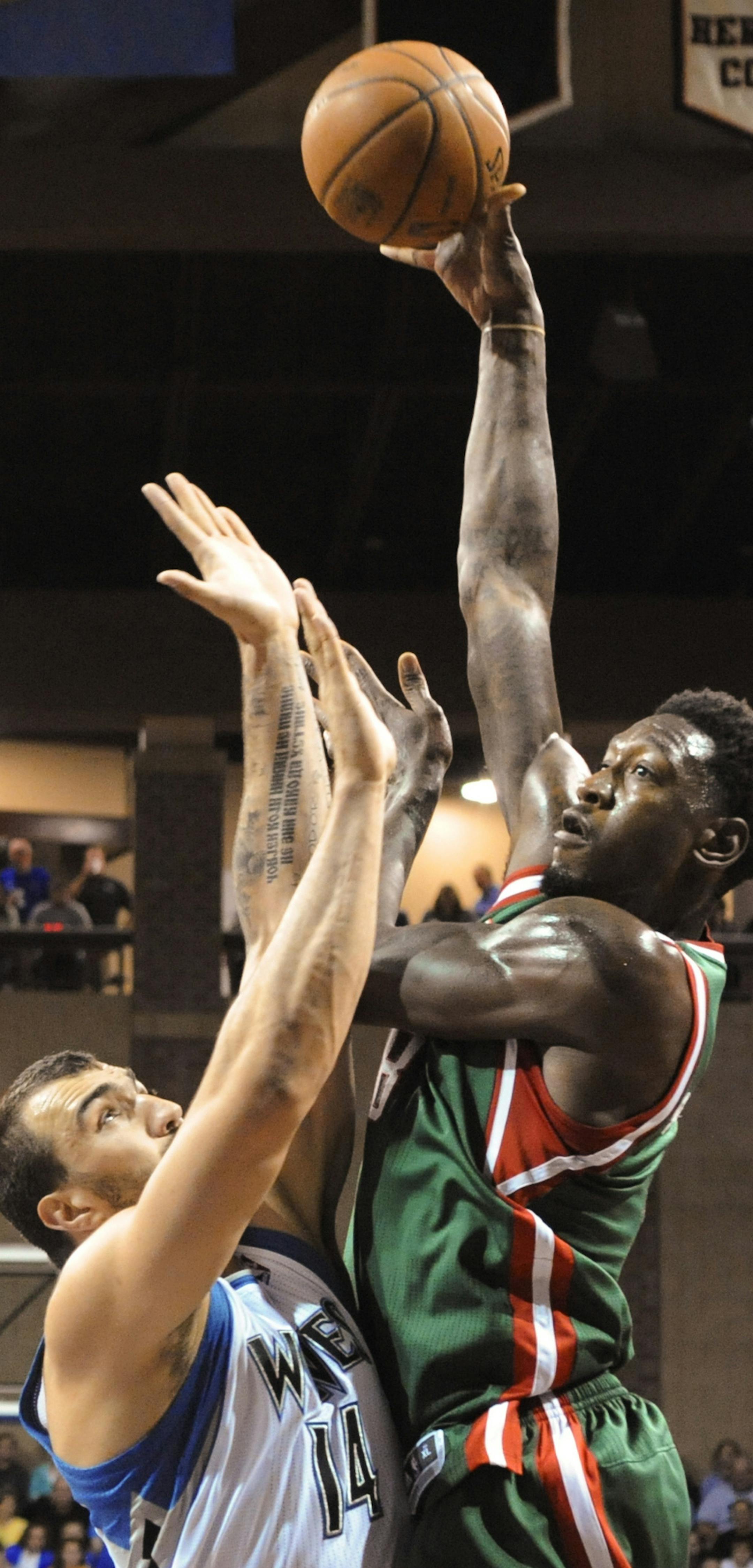 Milwaukee Bucks center Larry Sanders (8) takes a shot over Minnesota Timberwolves center Nikola Pekovic (14) during an NBA preseason basketball game in Sioux Falls, S.D., Thursday, Oct. 10, 2013. (AP Photo/Dave Weaver) ORG XMIT: MIN2013101021131900