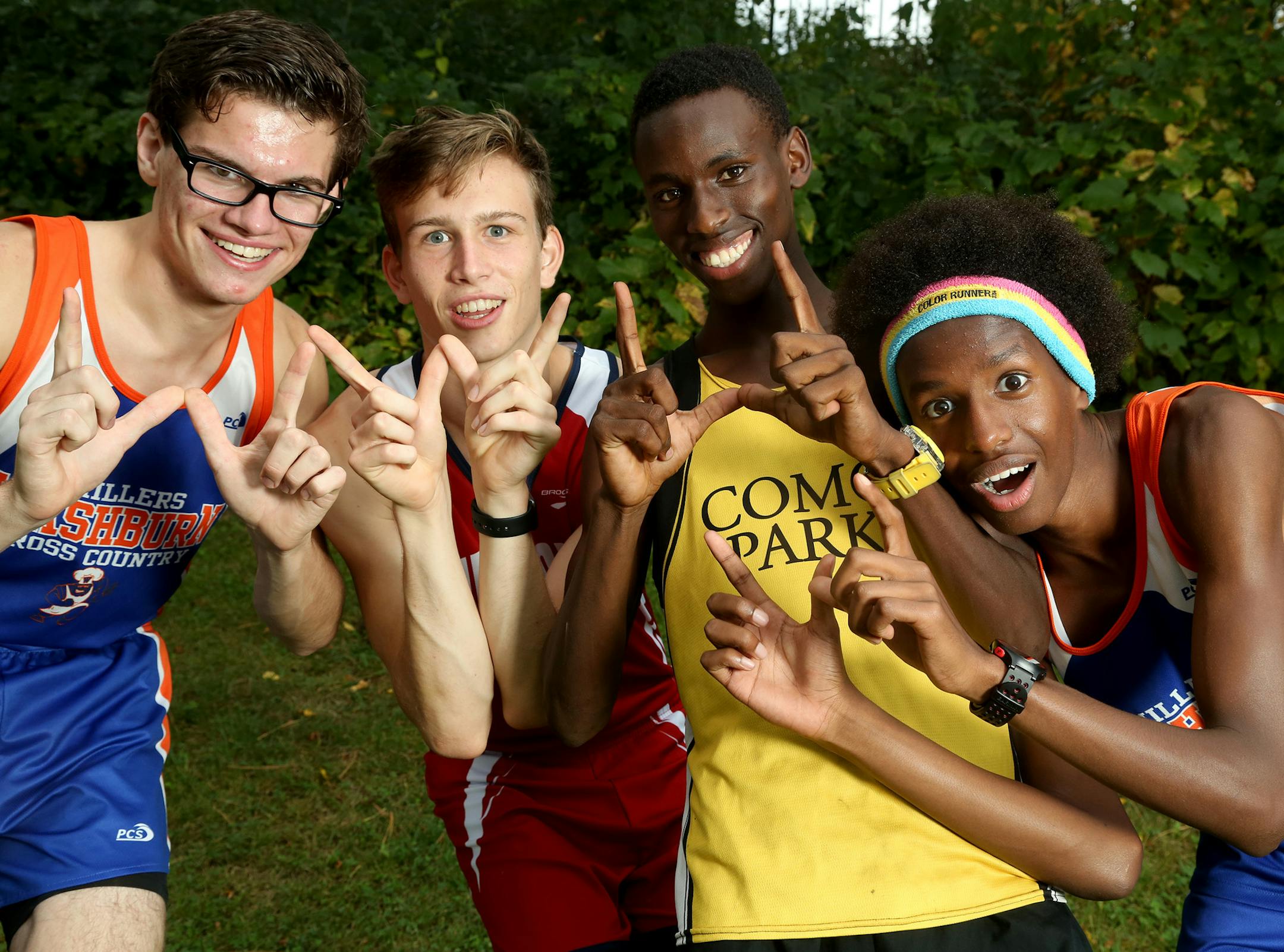 Cross country runners from left, Andrew Sell of Washburn, Micah Mather of St. Paul Highland Park, Hamza Ali of Washburn and Innocent Murwanashyaka of St. Paul Como Park fool around for the camera. ] (KYNDELL HARKNESS/STAR TRIBUNE) kyndell.harkness@startribune.com in Minneapolis Min., Tuesday September 23, 2015.
