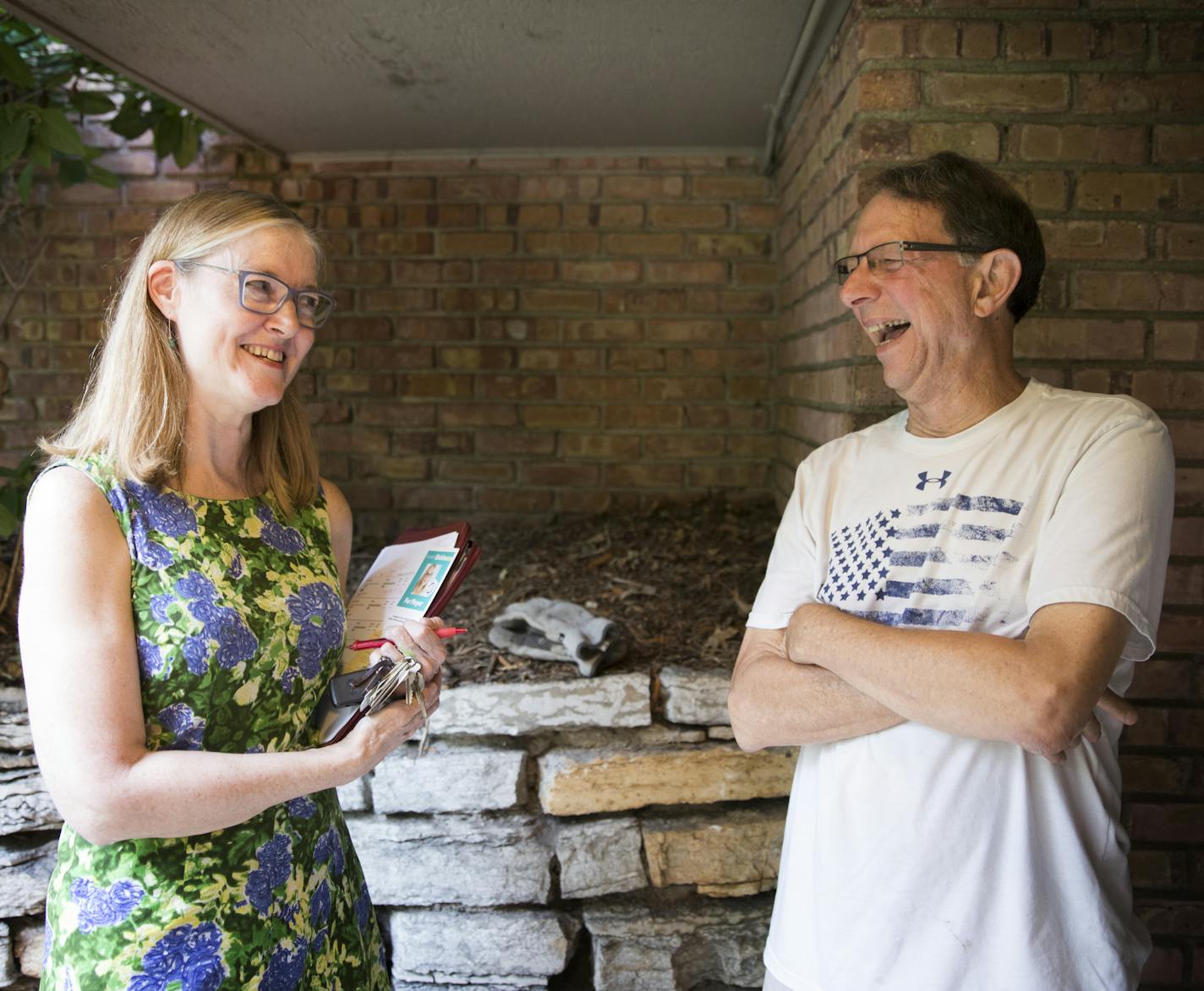 St. Paul mayoral candidate Elizabeth Dickinson, left, chats with Stuart Schmitz outside his home. ] LEILA NAVIDI &#xef; leila.navidi@startribune.com BACKGROUND INFORMATION: St. Paul mayoral candidate Elizabeth Dickinson goes door knocking in the Highland Park neighborhood in St. Paul on Tuesday, September 12, 2017.