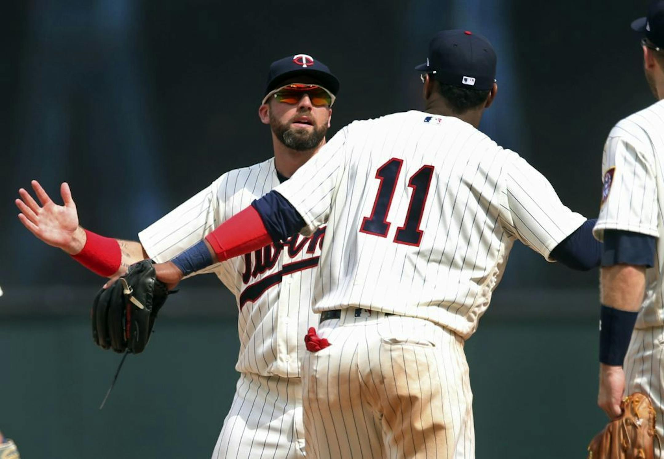 Minnesota Twins outfielder Jake Cave, left, and Jorge Polanco celebrate after the Twins beat the Kansas City Royals 8-5 in a baseball game Wednesday, July 11, 2018, in Minneapolis.
