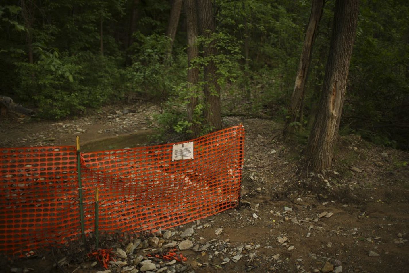 A temporary fence and a sign in Lilydale Regional Park announces the closing of trails that make up the Bruce Vento Watchable WIldlife viewing area and the fossil grounds Monday evening, June 2, 2014.