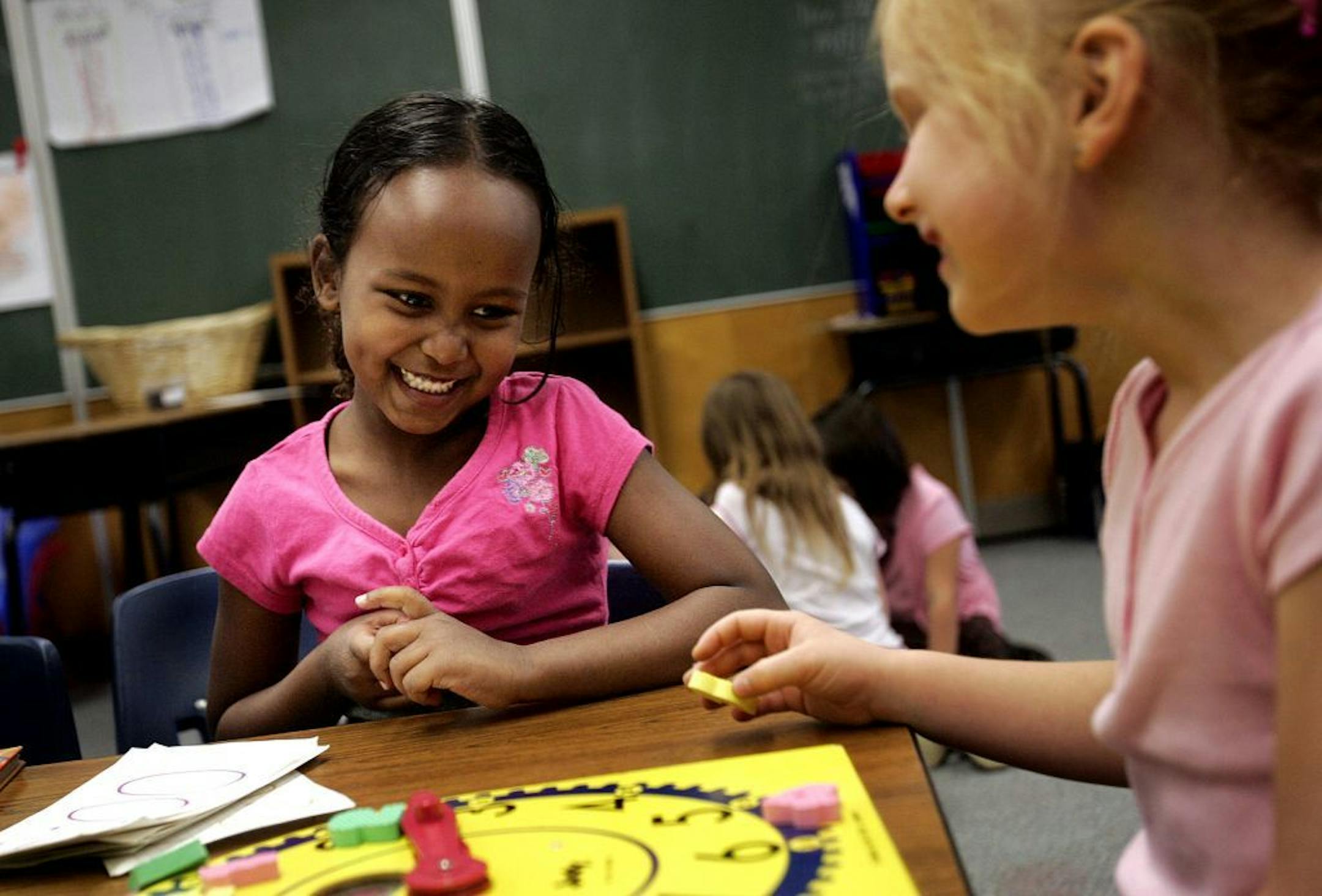 JEFFREY THOMPSON � jthompson@startribune.com Burnsville, MN - April 23, 2007 - All-day kindergarten Edward Neill Elementary kindergartners Halimo Osman, left, and Madison Kanz joke with each during a rotating station exercise Tuesday, April 23, 2007. GENERAL INFORMATION: Three years ago, the Burnsville school district ran a universal all-day kindergarten program, providing the program free for all the students in the district. The district has since stopped the program for financial reasons, but