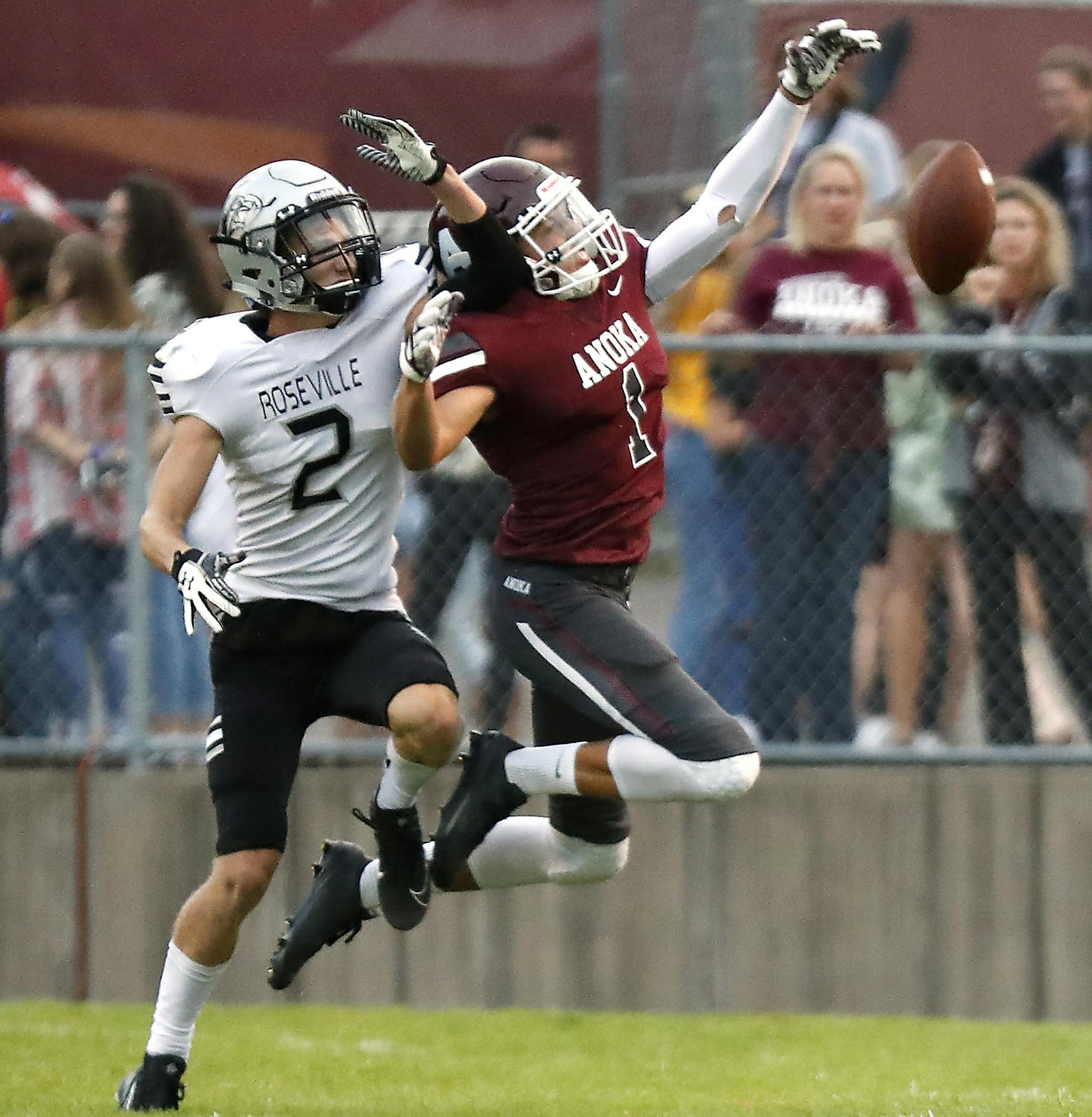 Anoka High School defensive back Charlie Buffie (1) deflects a pass intended for Roseville Area High School running back Latham Streeter (2) during the first half. ] LEILA NAVIDI ï leila.navidi@startribune.com BACKGROUND INFORMATION: Roseville Area High School plays against Anoka High School in the opening football game of the season in Anoka on Thursday, August 30, 2018.