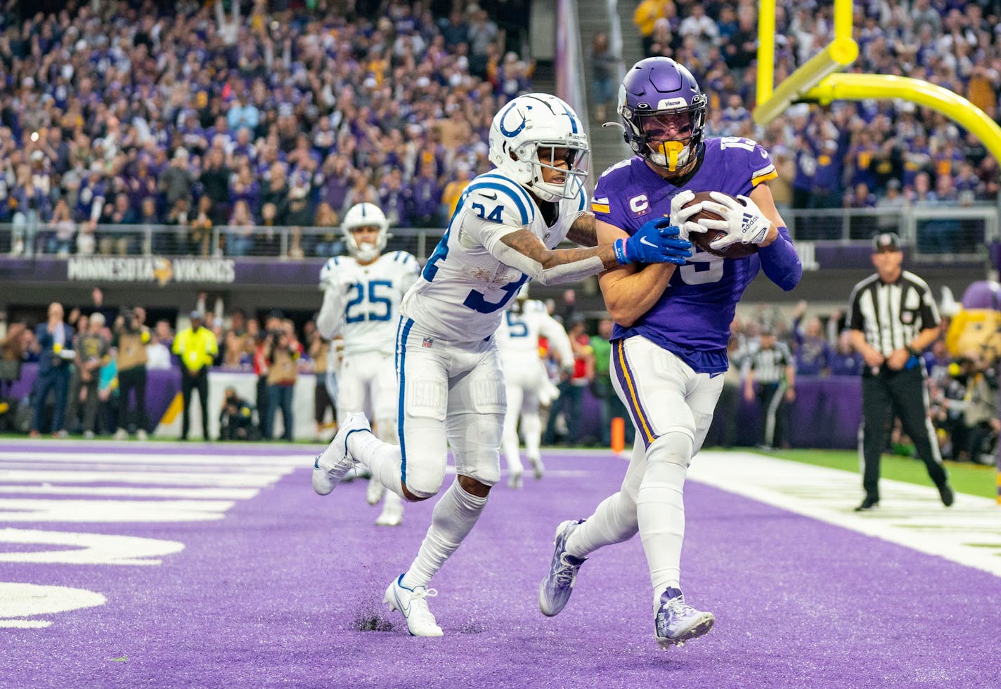 Minnesota Vikings wide receiver Adam Thielen (19) catches a touchdown in front of Indianapolis Colts cornerback Isaiah Rodgers (34) in the fourth quarter Saturday, Dec. 17, 2022 at U.S. Bank Stadium in Minneapolis. The Vikings completed the largest comeback in NFL history after starting the game down 33-0. ]