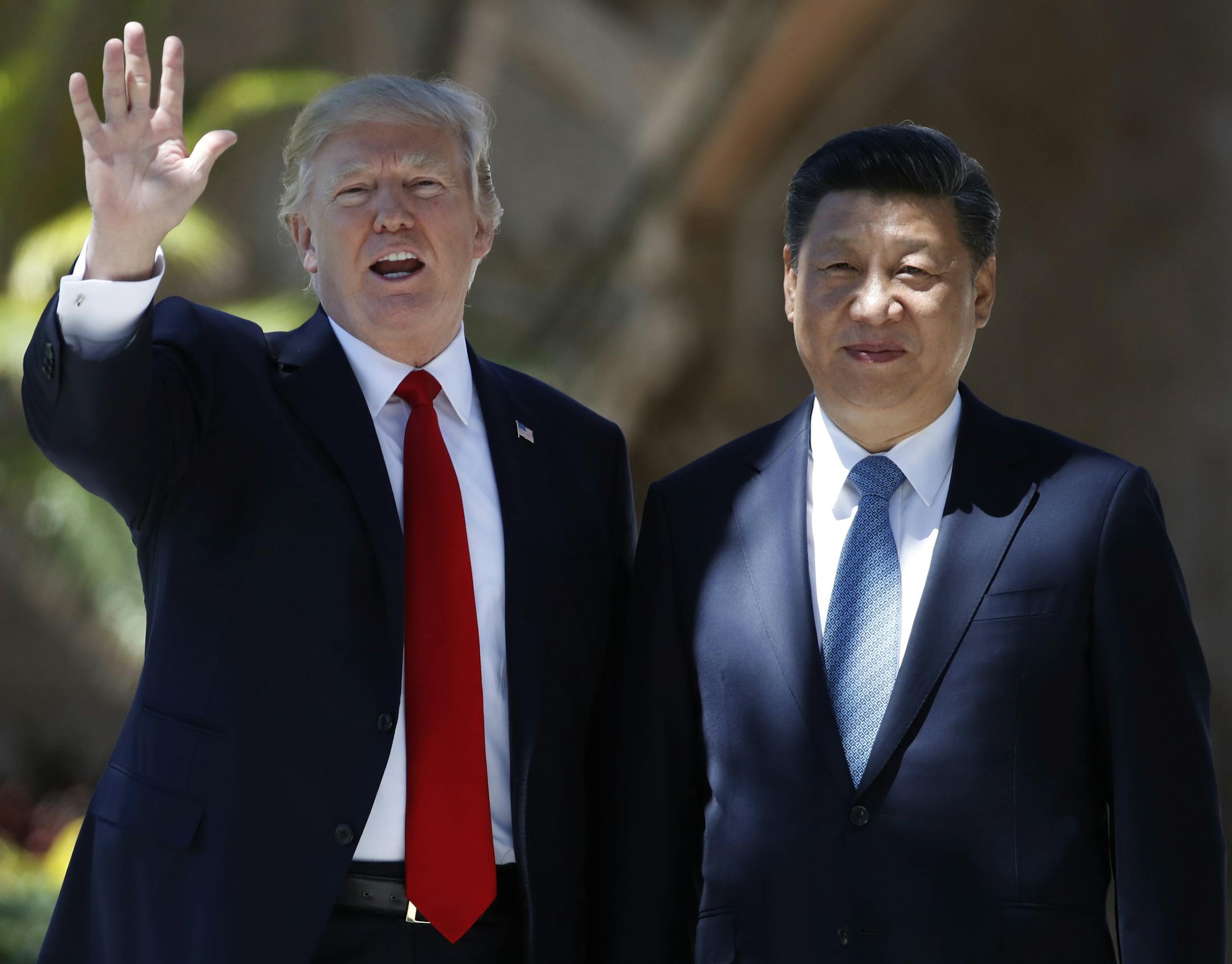 FILE - In this Friday, April 7, 2017 file photo, President Donald Trump and Chinese President Xi Jinping pause for photographs at Mar-a-Lago in Palm Beach, Fla. when Trump was meeting again with Xi with U.S. missile strikes on Syria adding weight to his threat to act unilaterally against the nuclear weapons program of China's ally, North Korea. North Korea has vowed to bolster its defenses to protect itself against airstrikes like the ones Trump ordered against an air base in Syria. The North ca